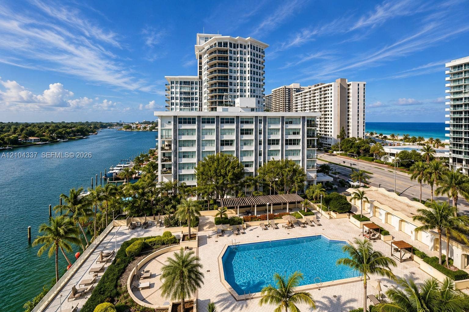 View from the private terrace, capturing Indian Creek to the west, the buildings resort-style pool below, and the Atlantic Ocean to the east.