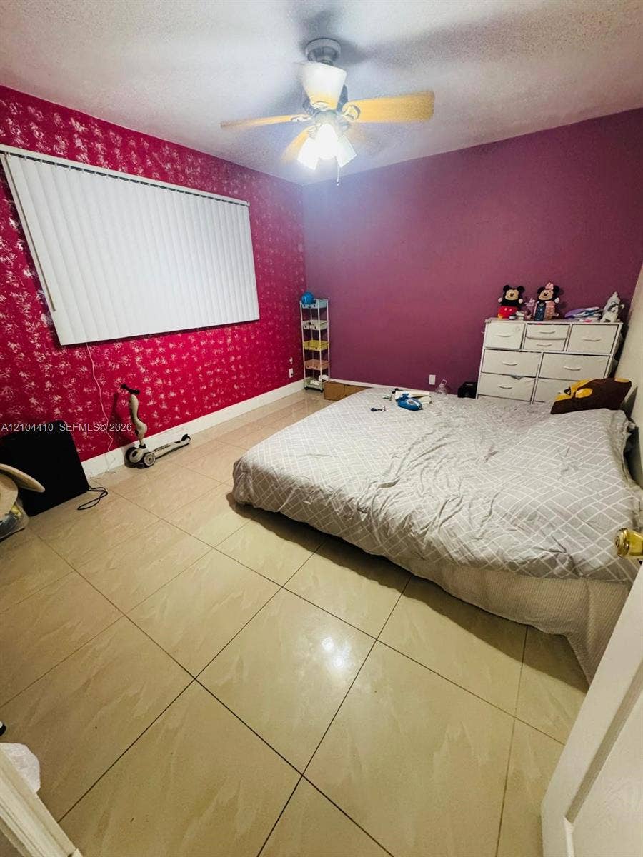 2312 Van Buren Street, #2, Hollywood, Hollywood, FL 33020 Large-format ceramic tile flooring, ceiling fan with integrated lighting, and window blinds