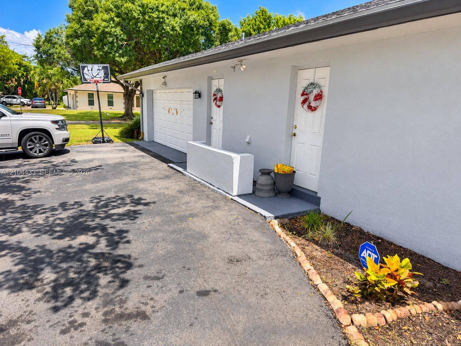 7380 NW 9th Street, Plantation, FL 33317 Stucco exterior with a single garage door and white entry doors