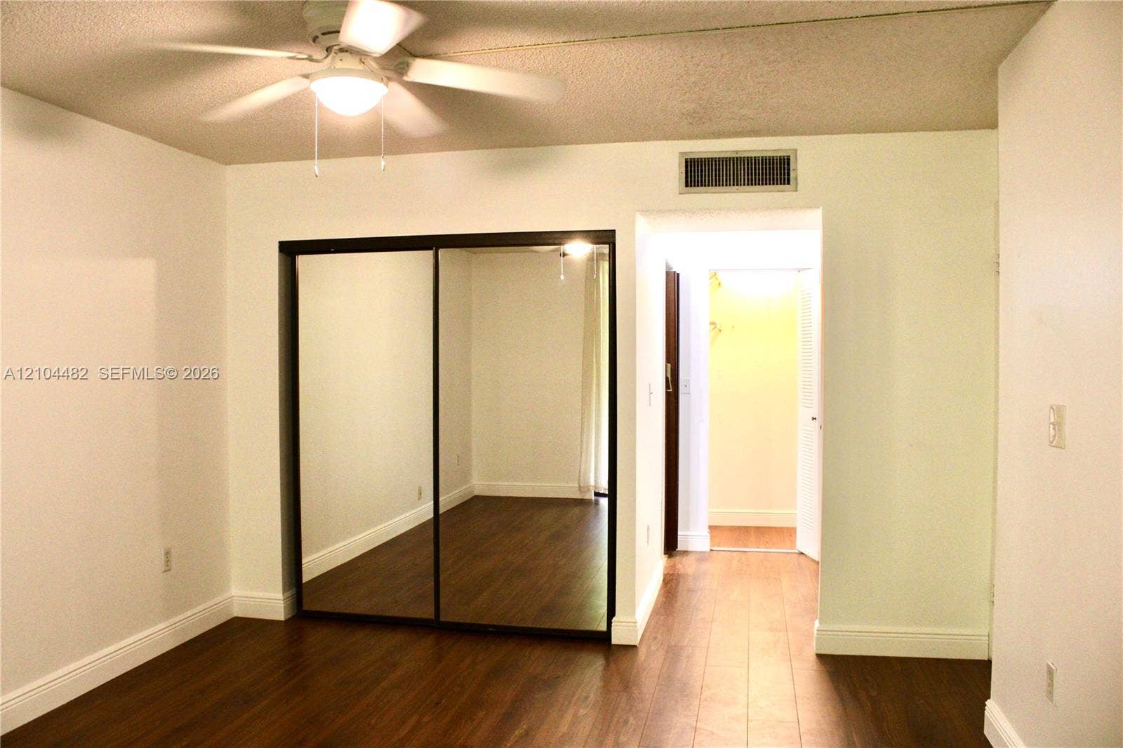 18000 NW 68th Avenue, #409A, Hialeah, Hialeah, FL 33015 Wood-finish flooring, ceiling fan with integrated lighting, and mirrored sliding closet doors