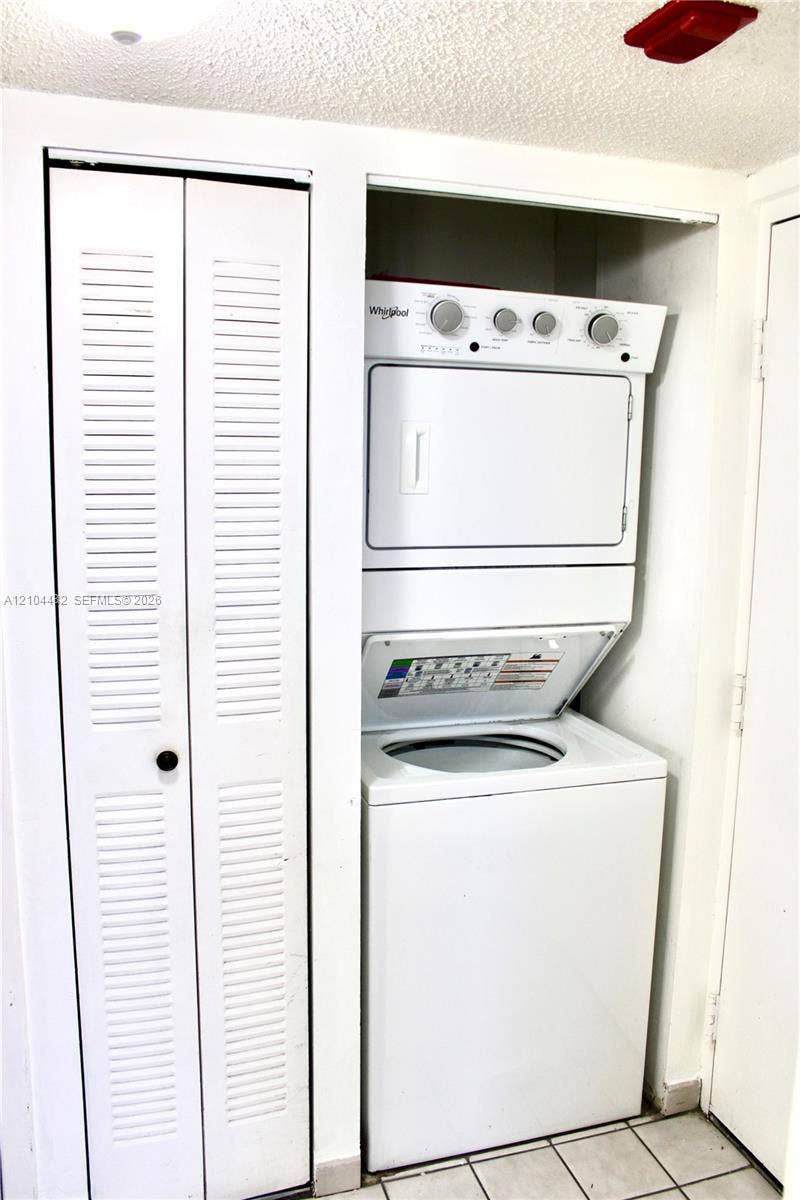 18000 NW 68th Avenue, #409A, Hialeah, Hialeah, FL 33015 Stackable laundry unit featuring a white finish and louvered bi-fold closet doors