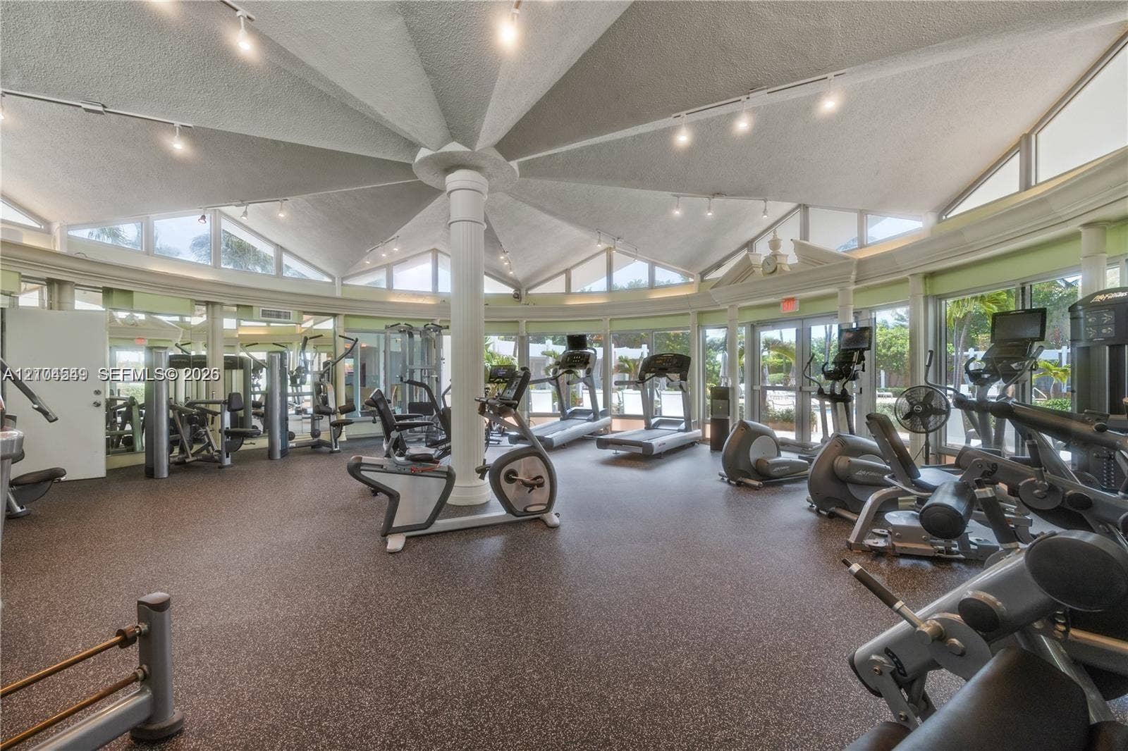 5055 Collins Avenue, #12F, Miami Beach, FL 33140 Spacious fitness center featuring a radial vaulted ceiling, extensive window line, and a resilient rubberized floor