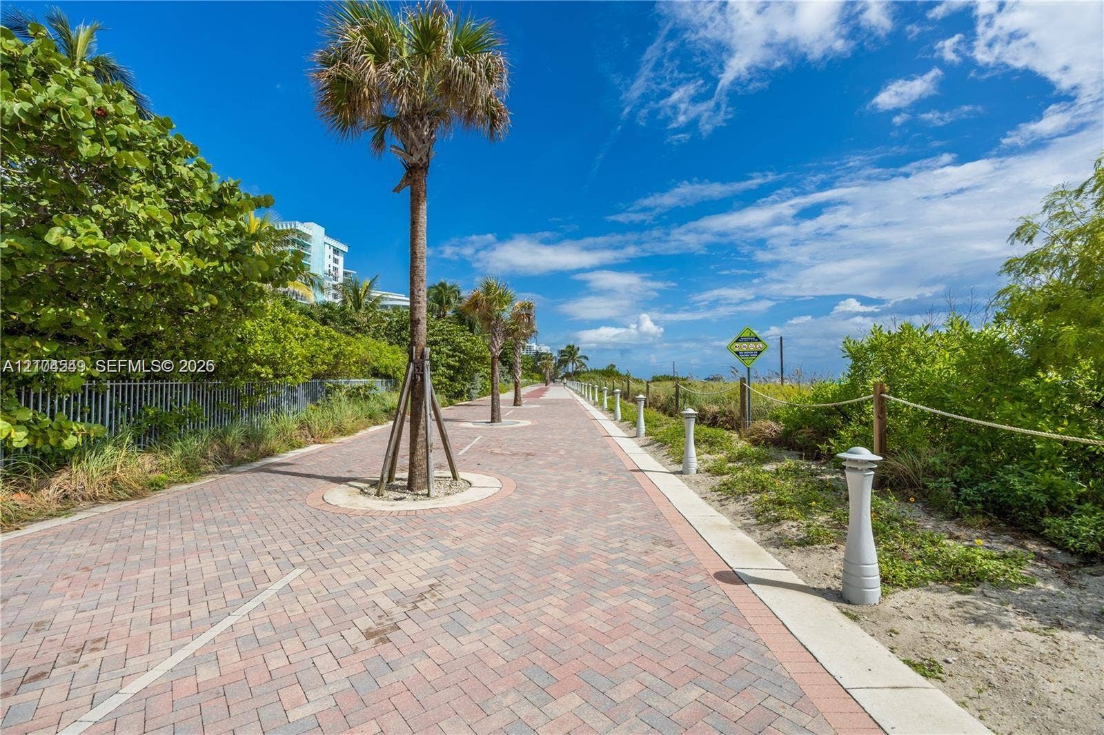 5055 Collins Avenue, #12F, Miami Beach, FL 33140 Paver walkway bordered by established vegetation and mature palm trees