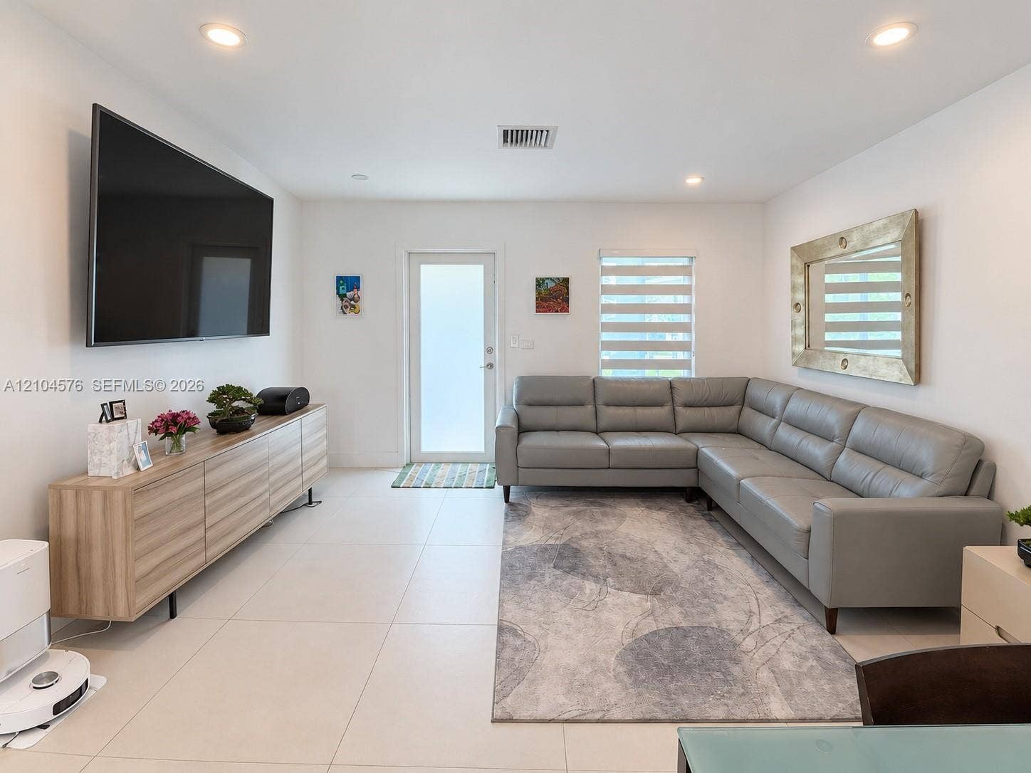 9755 SW 54th Street, Miami, Miami, FL 33165 Large-format tile flooring, recessed lighting, and dual-shade window coverings featuring a glass-panel entry door