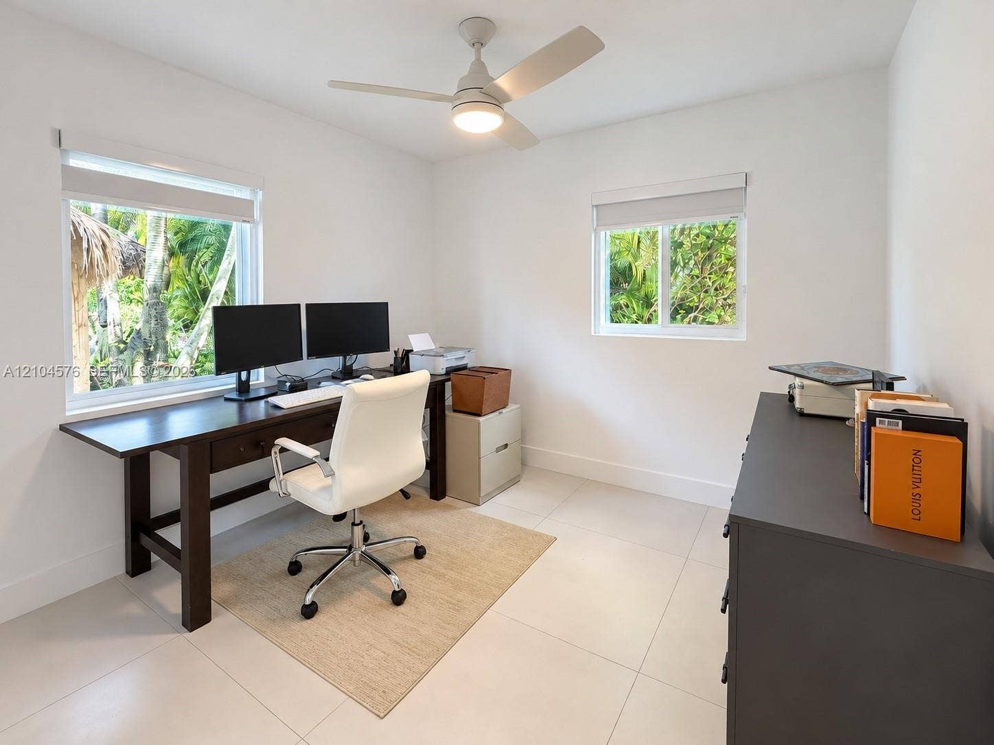 9755 SW 54th Street, Miami, Miami, FL 33165 Bright interior featuring large windows, neutral tile flooring, and an integrated ceiling fan with a central light fixture
