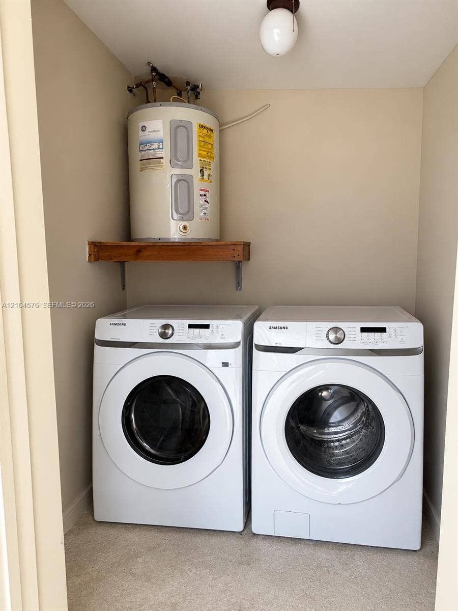 9755 SW 54th Street, Miami, Miami, FL 33165 Dedicated laundry area featuring a wall-mounted wood shelf and globe-style ceiling lighting