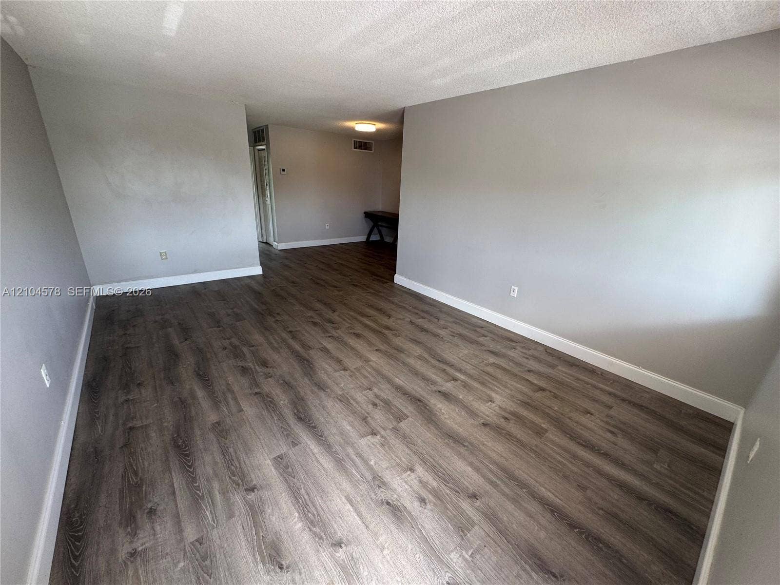 20320 NE 2nd Avenue, #22, Miami Gardens, Miami Gardens, FL 33179 Wood-finish flooring throughout, stainless steel refrigerator, white cabinetry, and exterior door with glass insert