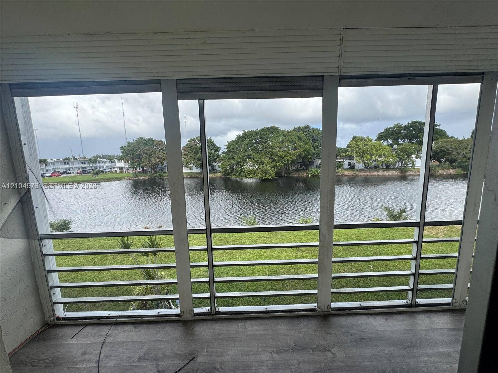 20320 NE 2nd Avenue, #22, Miami Gardens, Miami Gardens, FL 33179 Enclosed patio featuring aluminum framing, wood-finish flooring, and direct water frontage