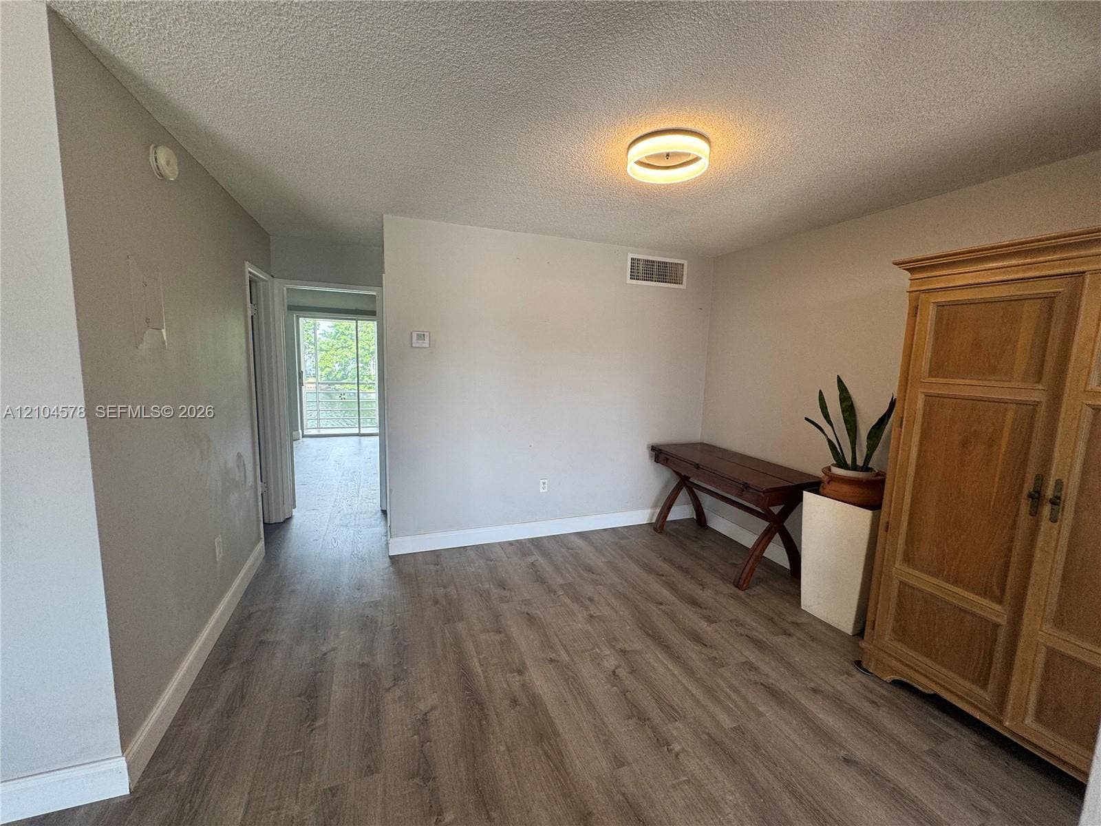 20320 NE 2nd Avenue, #22, Miami Gardens, Miami Gardens, FL 33179 Neutral interior featuring wood-finish flooring and a circular flush-mount ceiling fixture