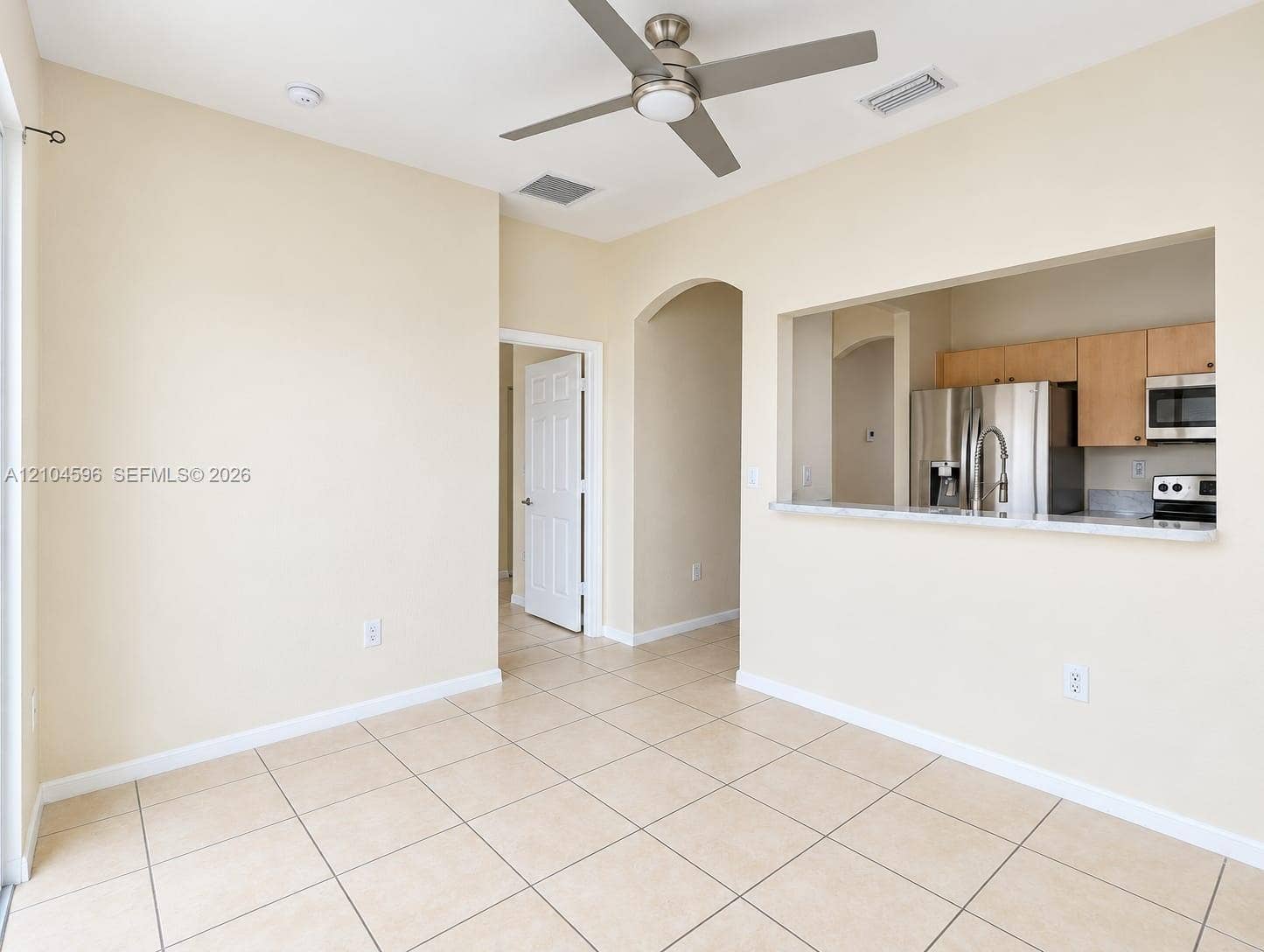 10968 SW 236th Terrace, Homestead, Homestead, FL 33032 Tile flooring, ceiling fan with integrated lighting, pass-through opening to kitchen, stainless steel kitchen appliances, and shaker-style cabinetry