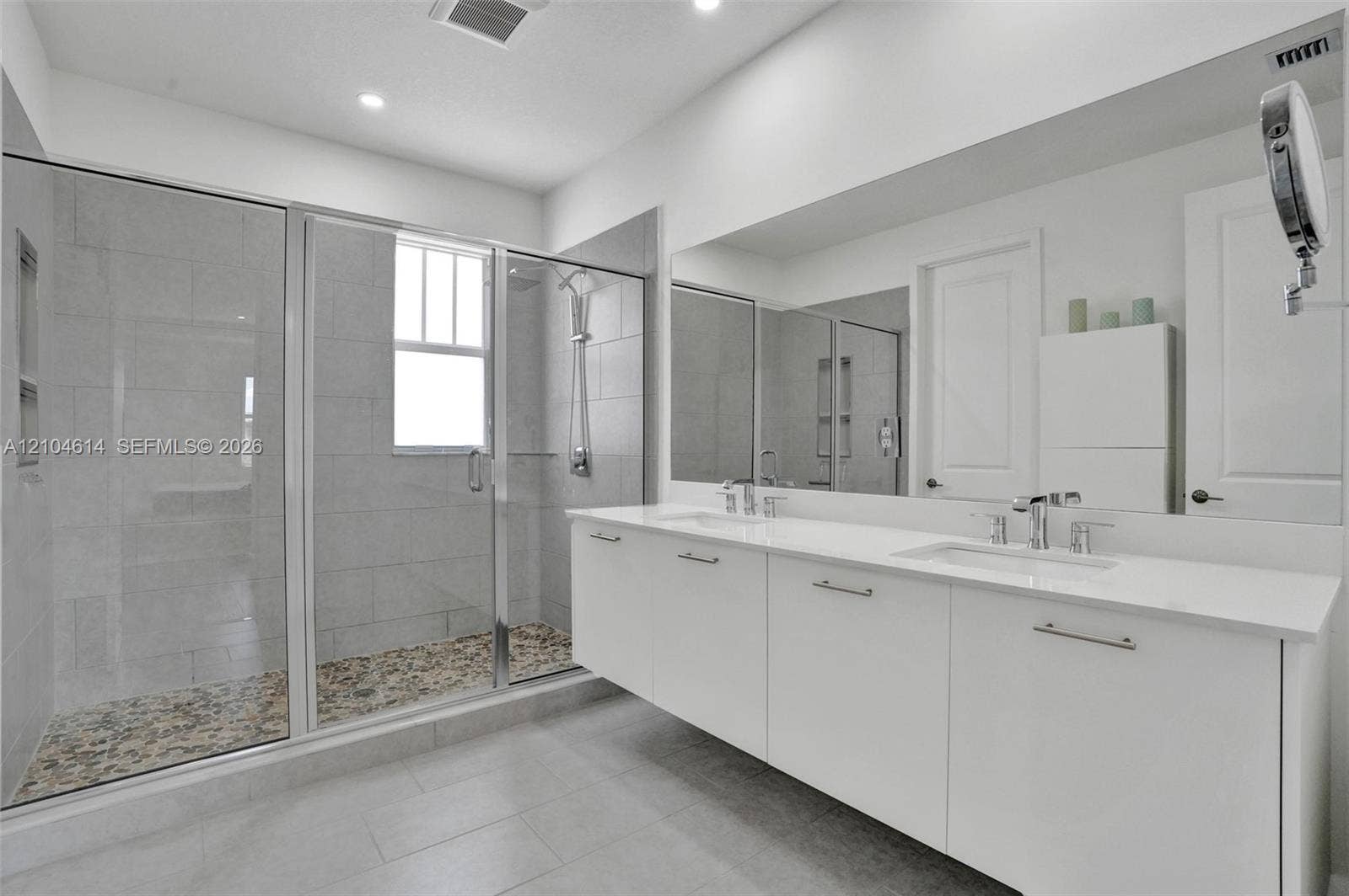 12240 SW 44th Court, Davie, FL 33330 Floating double vanity with a white countertop and chrome fixtures