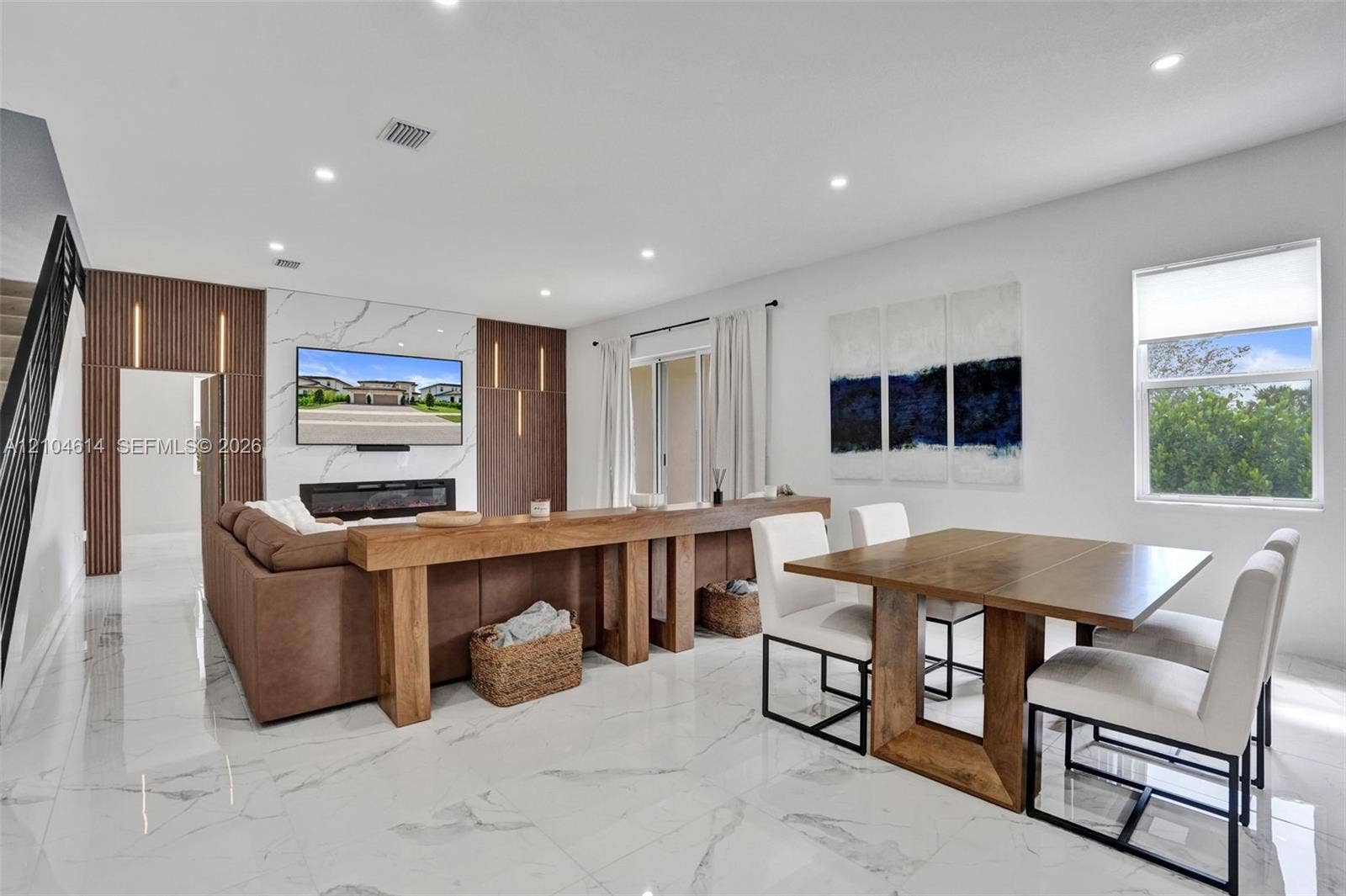 12240 SW 44th Court, Davie, FL 33330 Open-concept living space with large format porcelain tile flooring, recessed lighting, and a contemporary linear fireplace