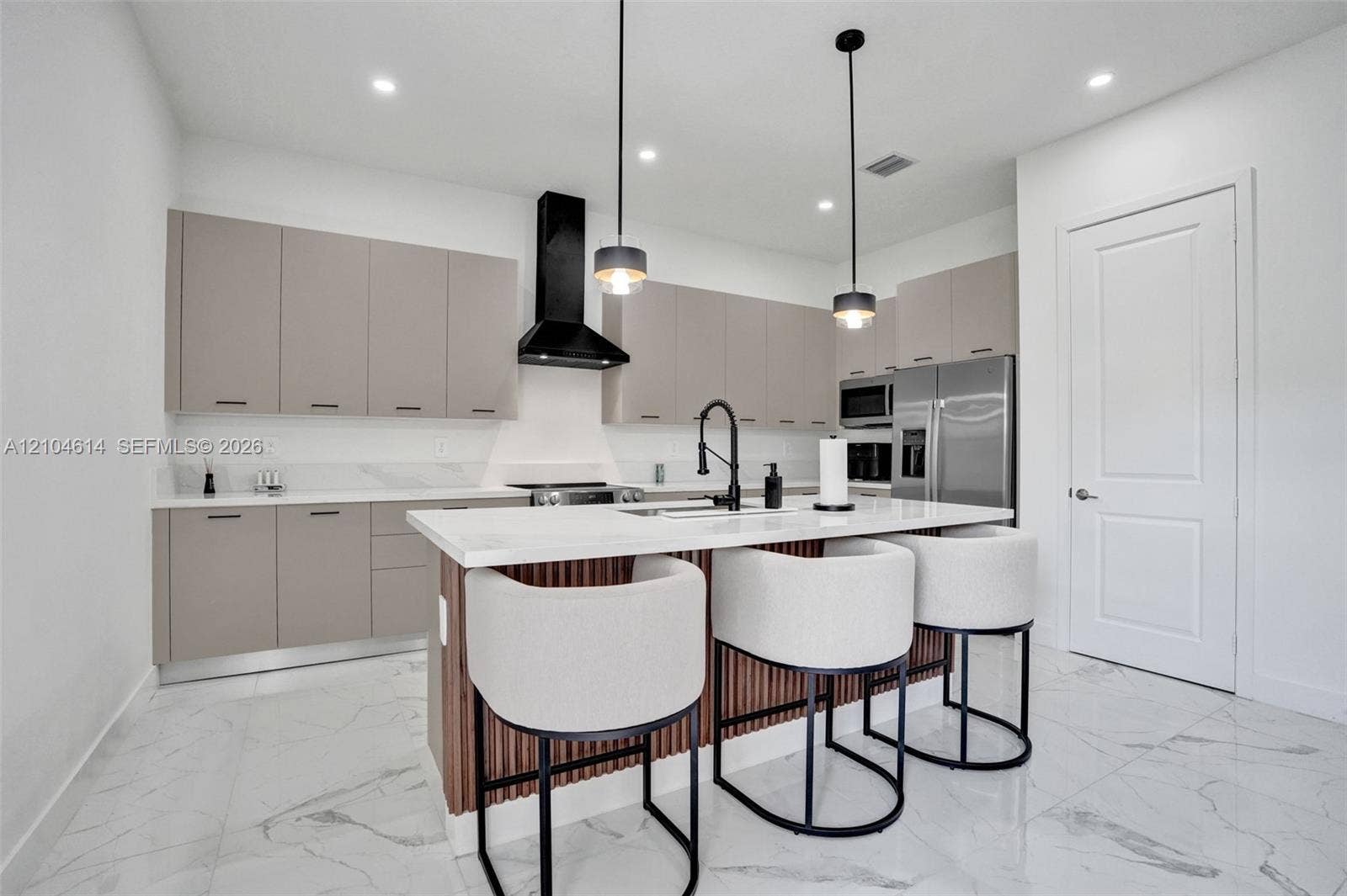 12240 SW 44th Court, Davie, FL 33330 Kitchen featuring an island with white countertop, matte black faucet, and pendant lighting
