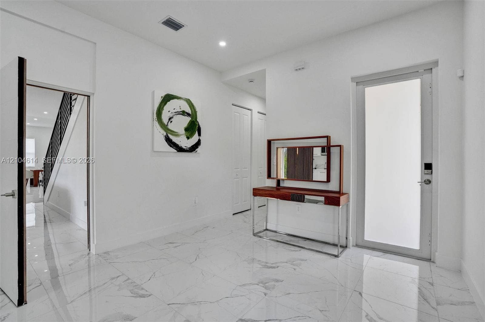 12240 SW 44th Court, Davie, FL 33330 White marble-finish flooring throughout, recessed ceiling lighting, and a white interior door with contemporary hardware