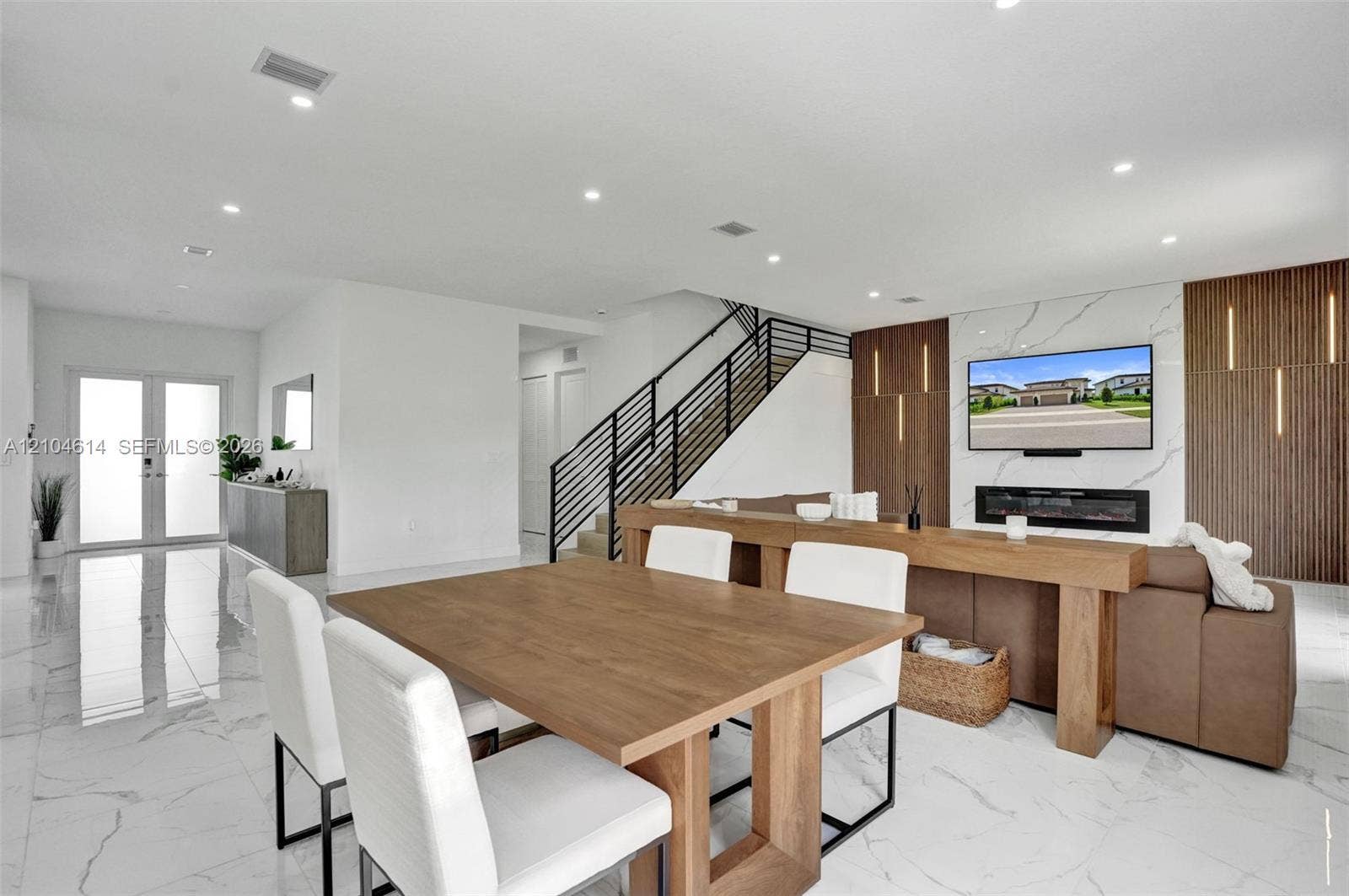 12240 SW 44th Court, Davie, FL 33330 White tile flooring, recessed lighting, and a modern staircase with black railings