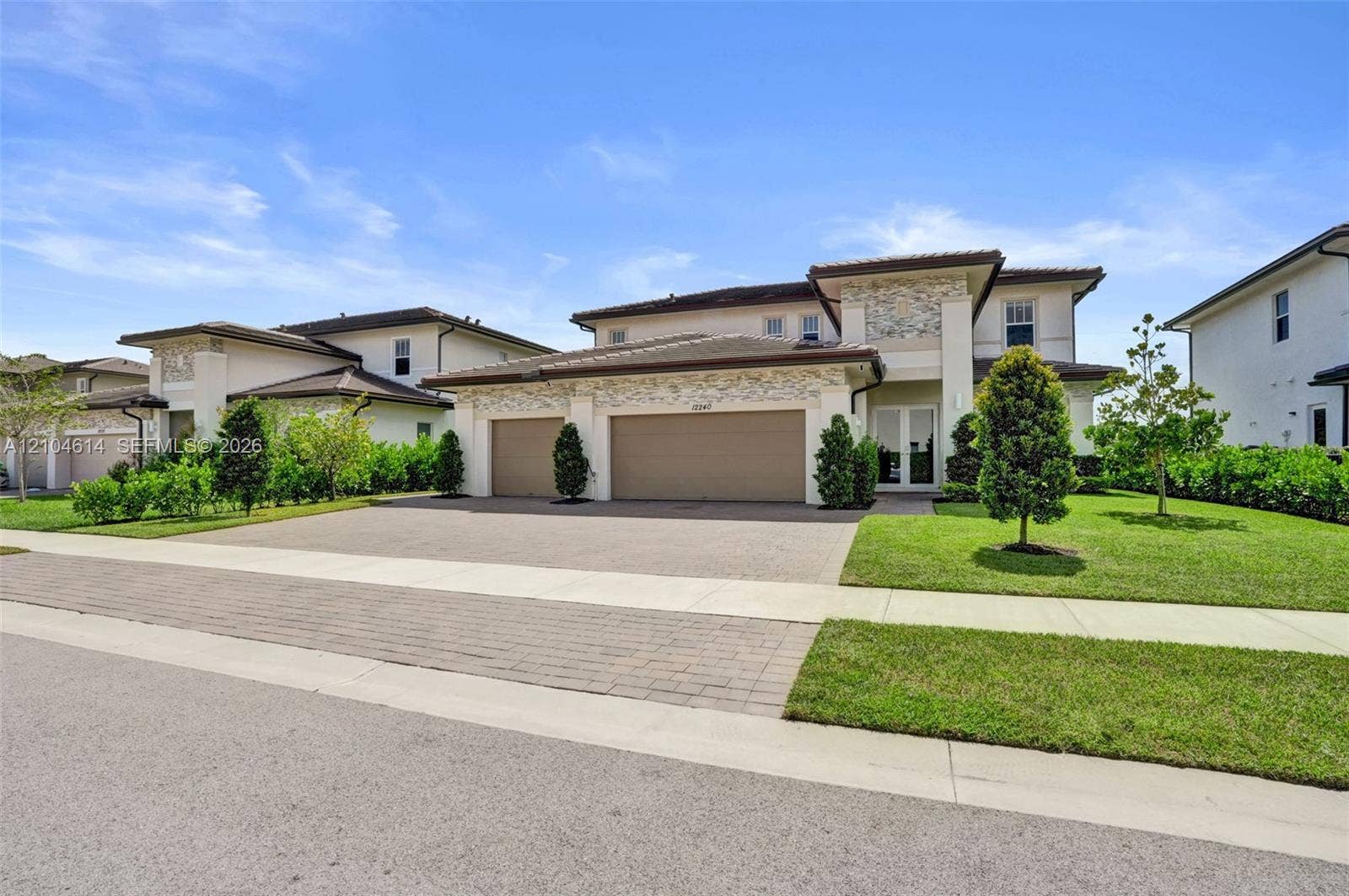 12240 SW 44th Court, Davie, FL 33330 Contemporary-style residence featuring a textured stone facade and a paver driveway