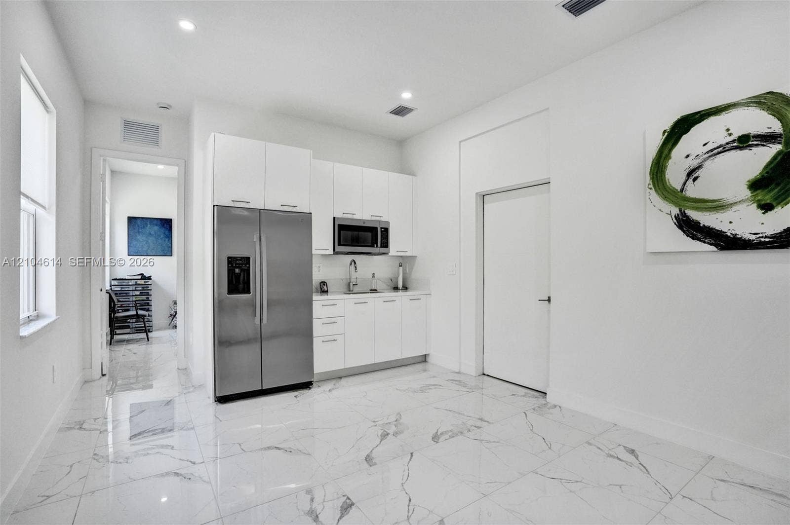 12240 SW 44th Court, Davie, FL 33330 Kitchenette featuring stainless steel appliances, white cabinetry, undermount sink, and recessed lighting