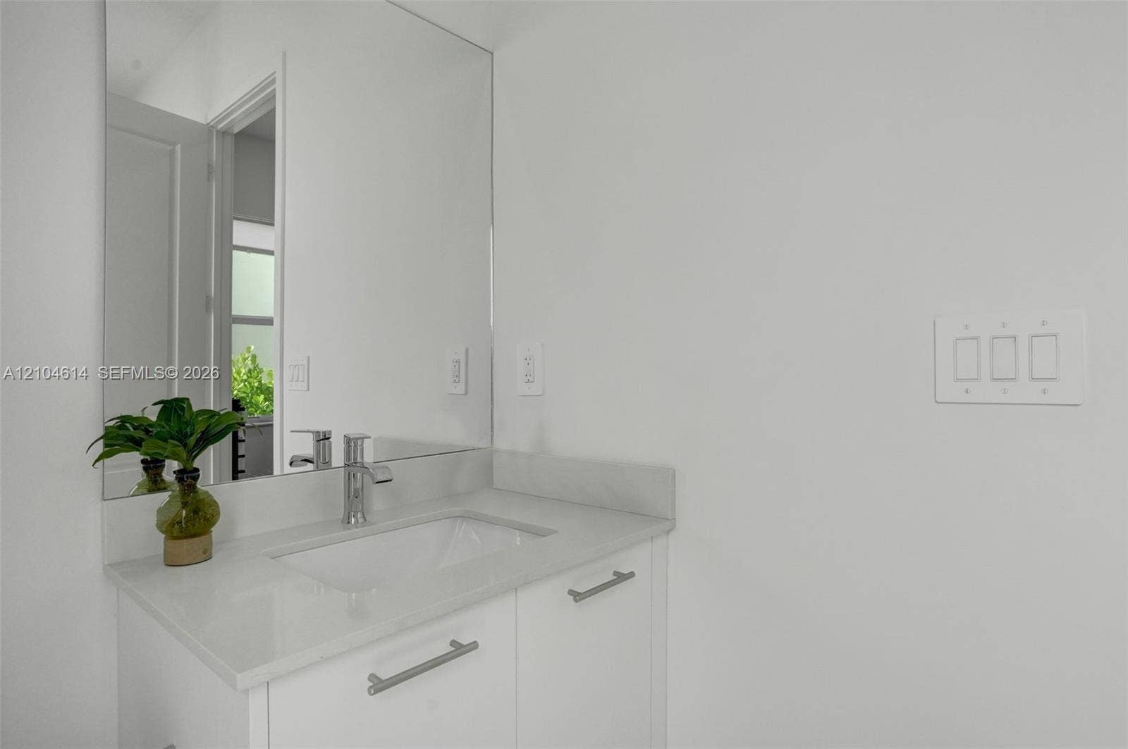 12240 SW 44th Court, Davie, FL 33330 White vanity with an integrated rectangular sink, chrome faucet, and full-width mirror