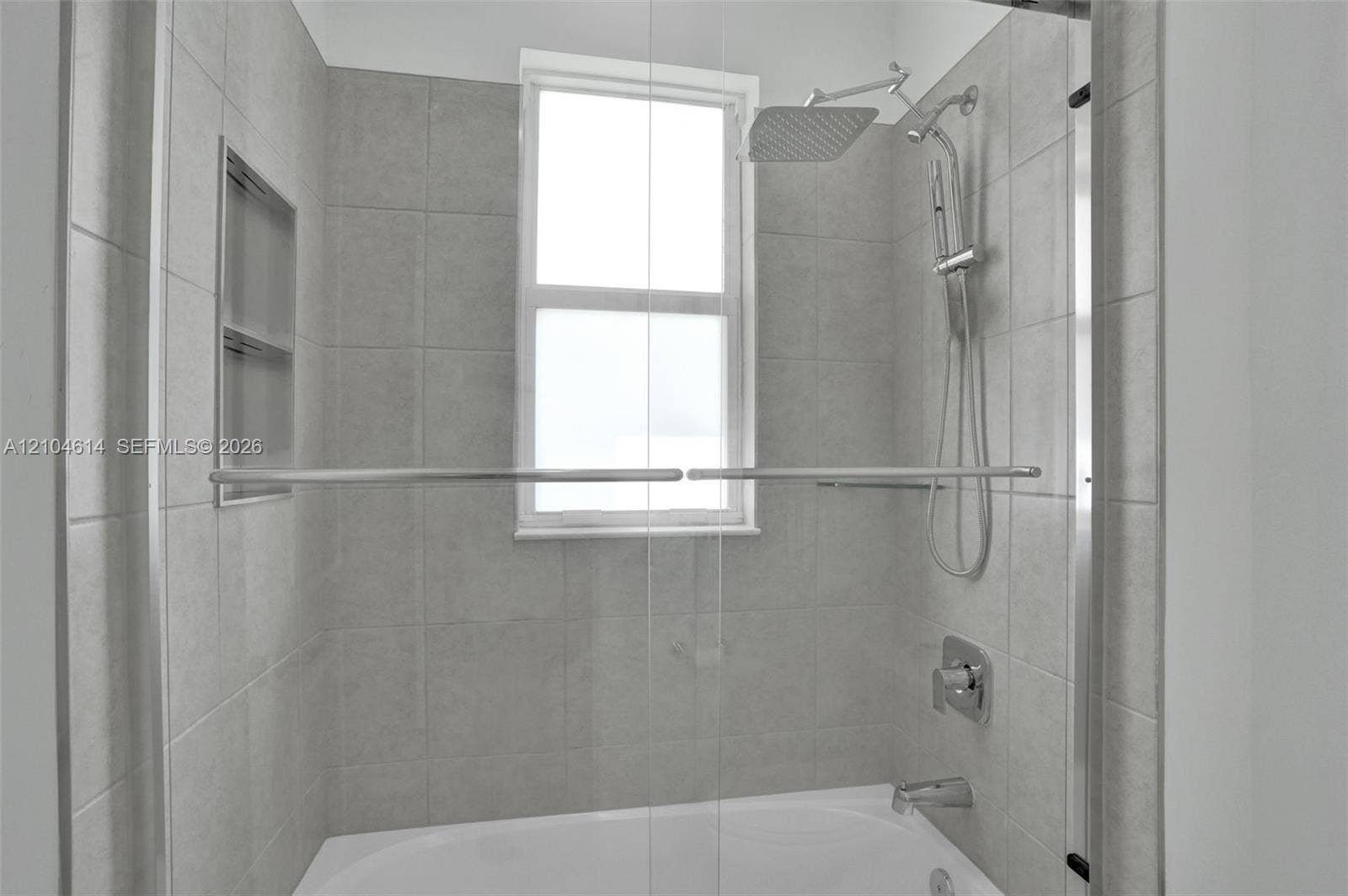12240 SW 44th Court, Davie, FL 33330 Bathtub with tile surround, built-in shower niche, and multi-function showerhead