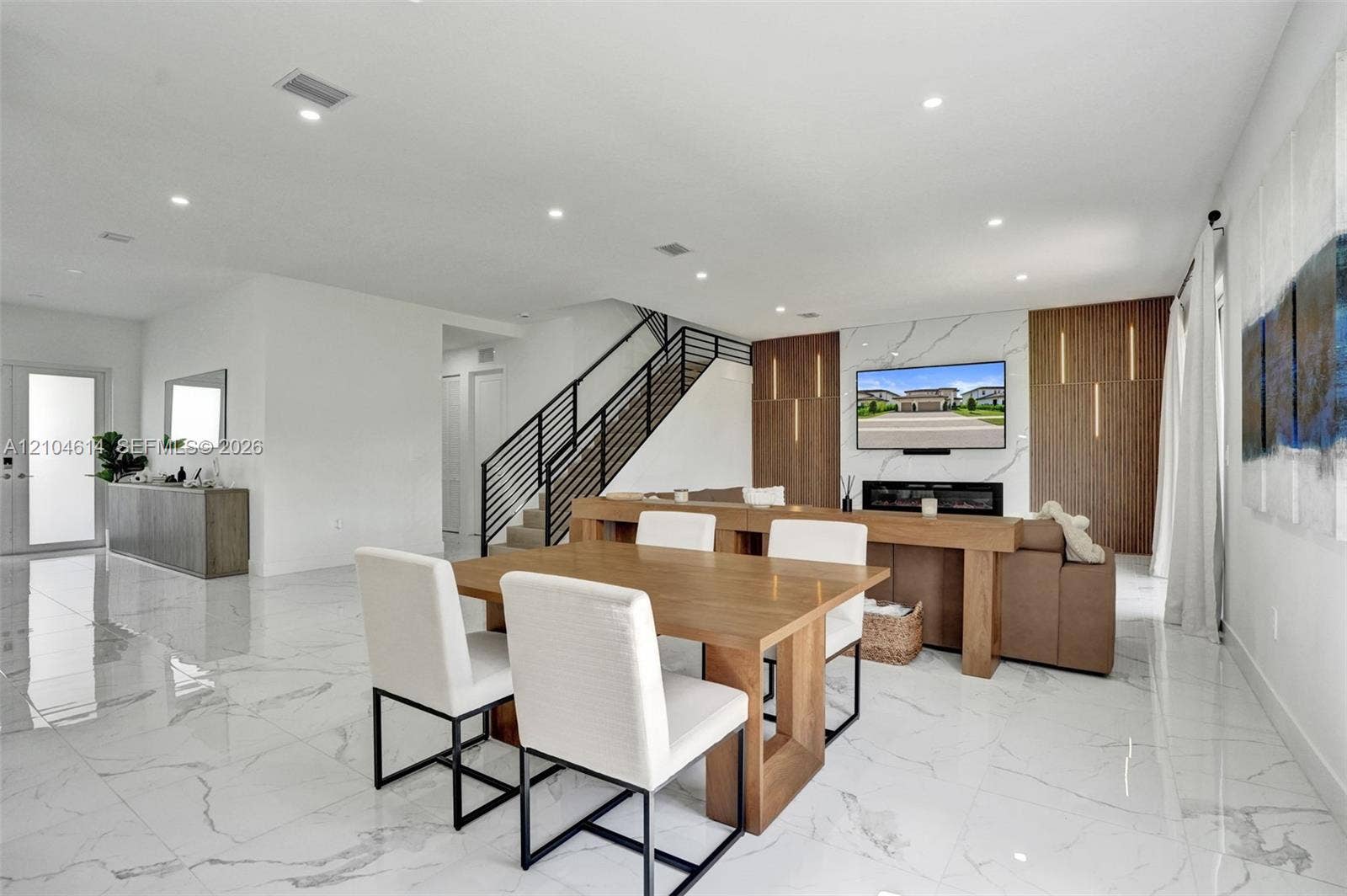 12240 SW 44th Court, Davie, FL 33330 Recessed lighting illuminates the open-concept living space with white walls and large format tile flooring