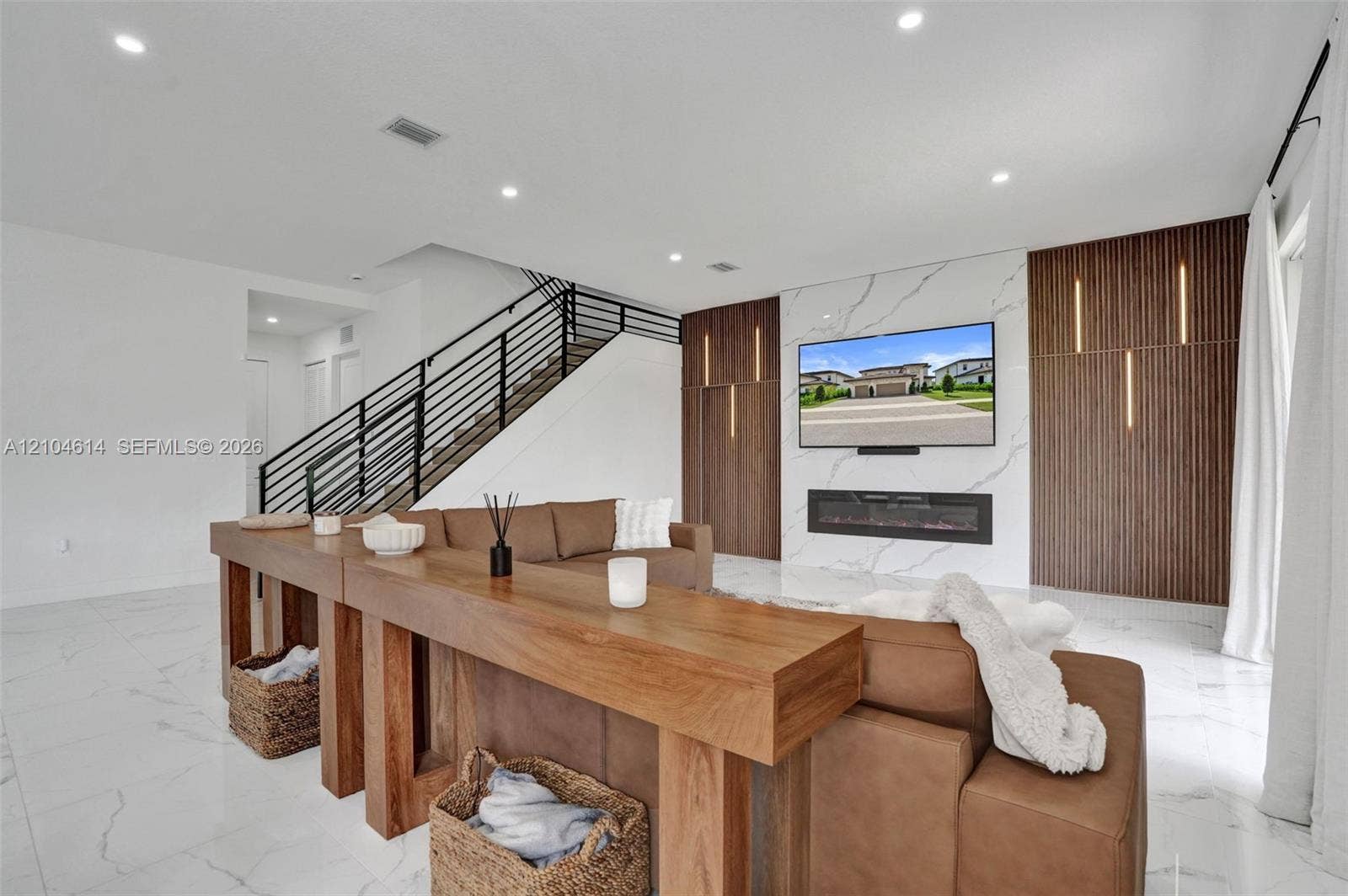 12240 SW 44th Court, Davie, FL 33330 Modern white tile flooring, recessed lighting, and a contemporary linear fireplace