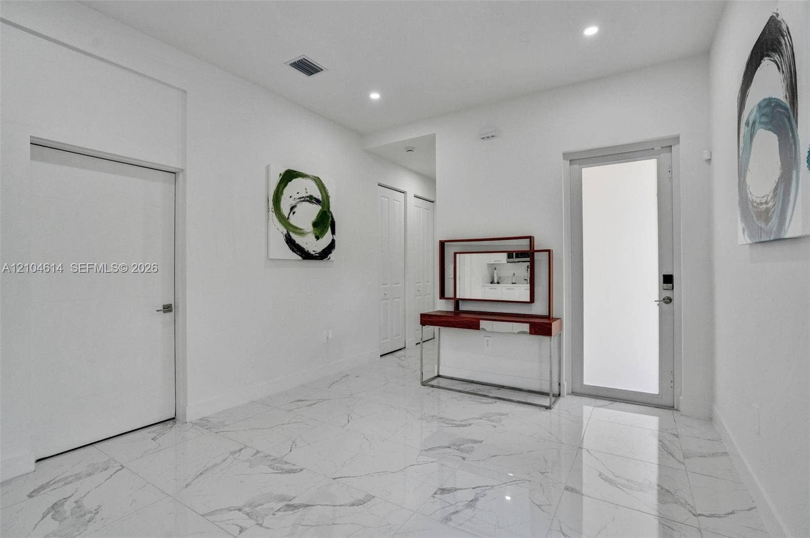 12240 SW 44th Court, Davie, FL 33330 Polished tile flooring, recessed lighting, and white walls create a bright interior