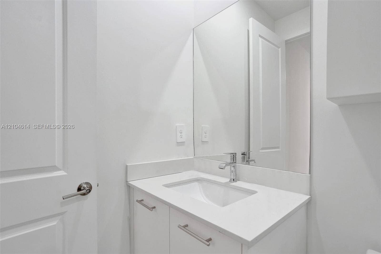 12240 SW 44th Court, Davie, FL 33330 Modern vanity with an integrated rectangular sink, chrome faucet, and substantial wall mirror