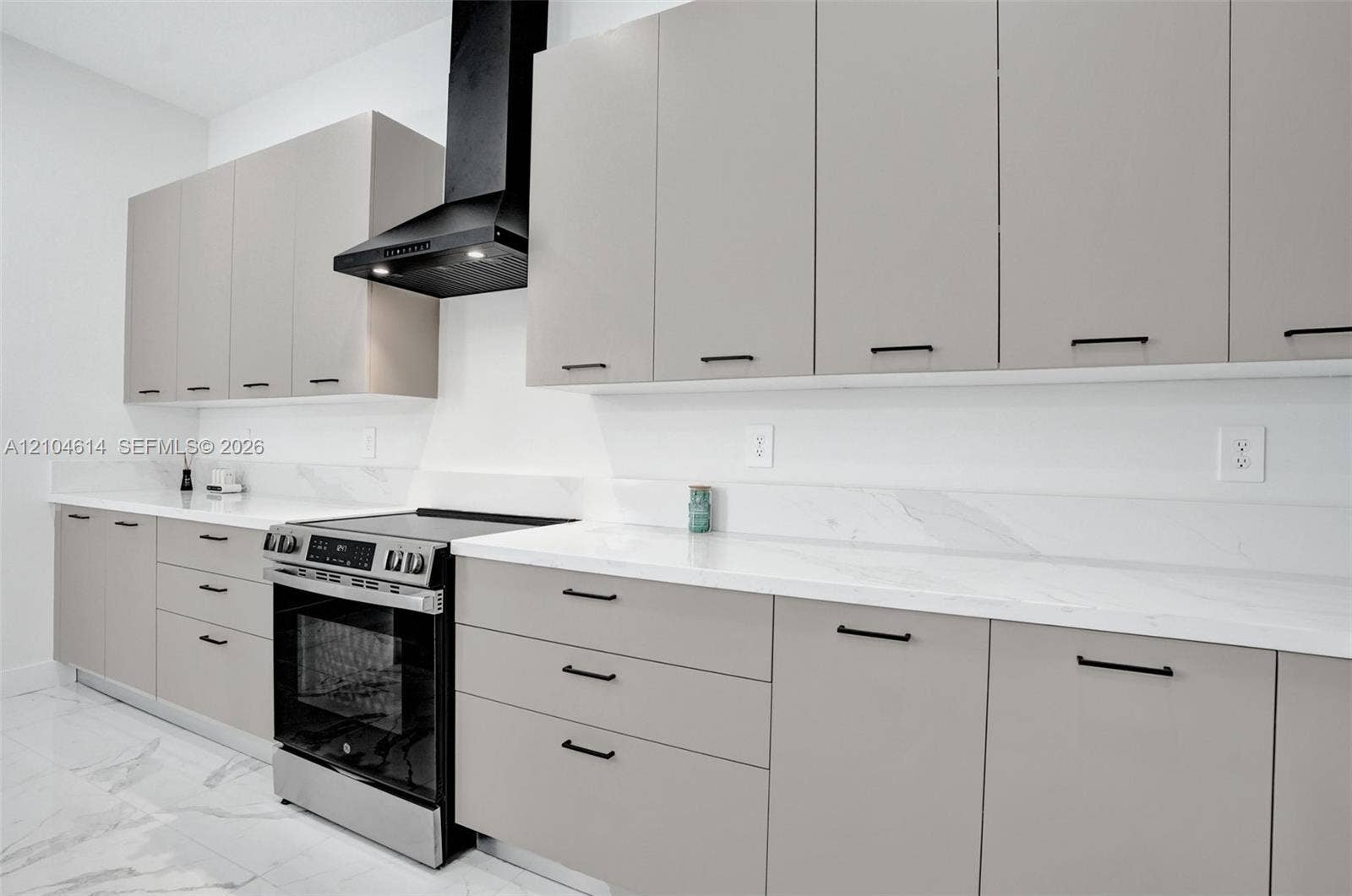 12240 SW 44th Court, Davie, FL 33330 Modern kitchen featuring light gray cabinetry, white countertops, black cabinet hardware, a stainless steel range, and a black range hood
