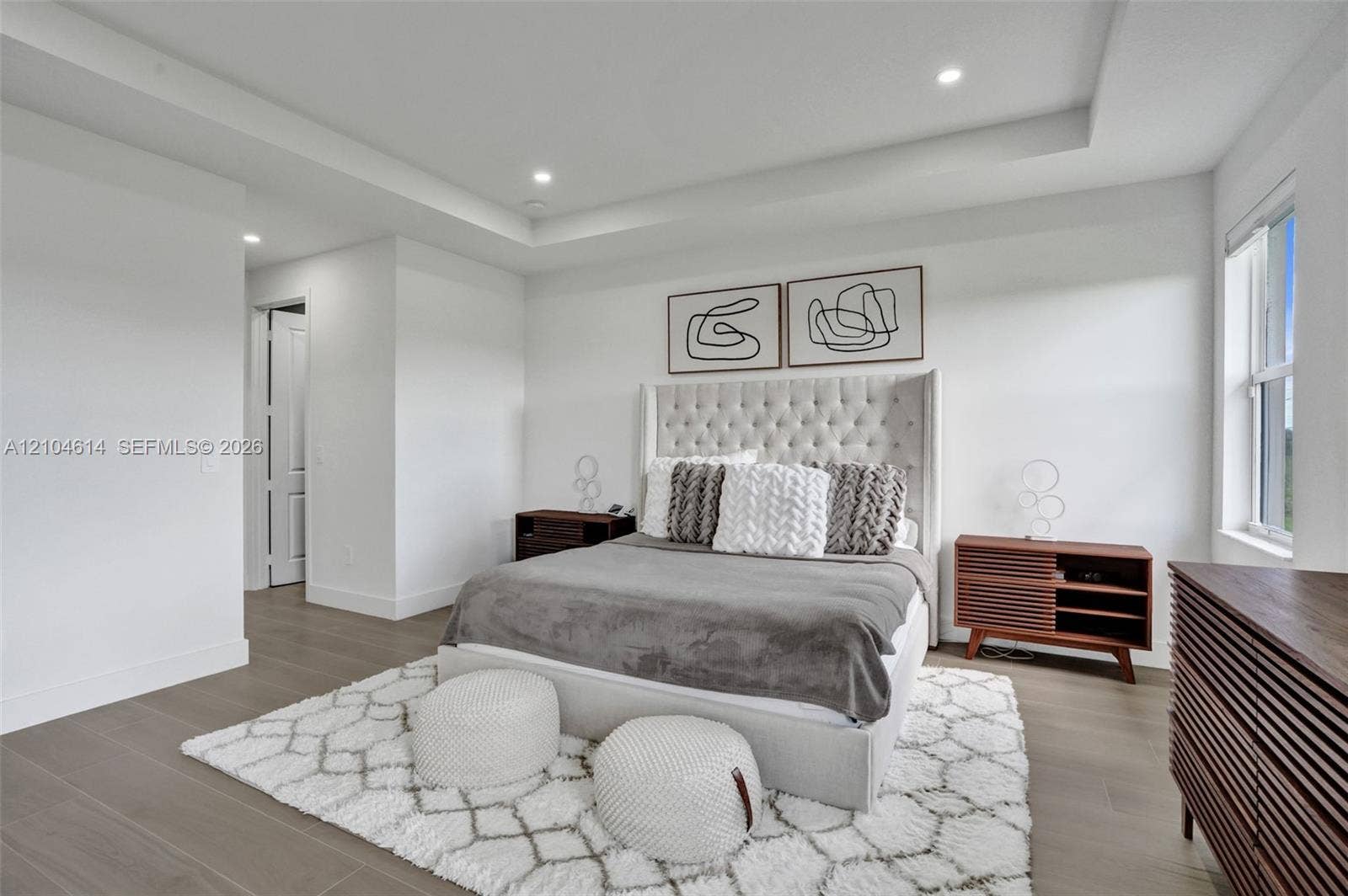 12240 SW 44th Court, Davie, FL 33330 Tray ceiling with recessed lighting, wood look flooring, and a large window