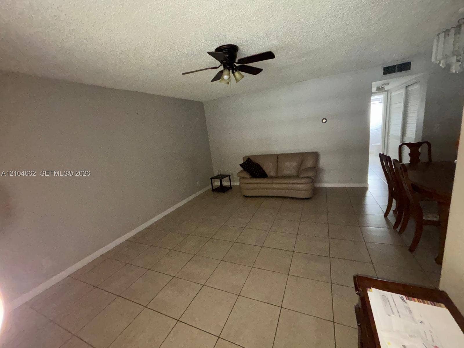 180 NE 12th Avenue, #12A, Hallandale Beach, Hallandale Beach, FL 33009 Spacious living area featuring tile flooring, a ceiling fan, and a neutral wall color
