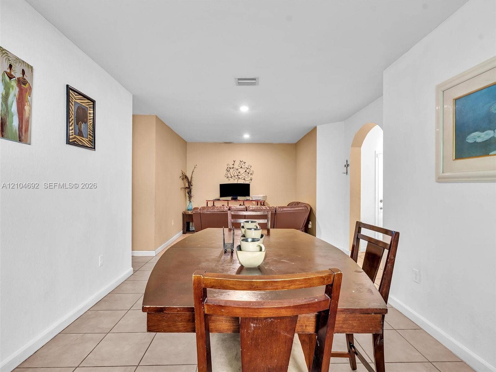714 SE 37th Place, Homestead, FL 33033 Neutral-toned interior featuring ceramic tile flooring, recessed lighting, and a decorative arched entryway