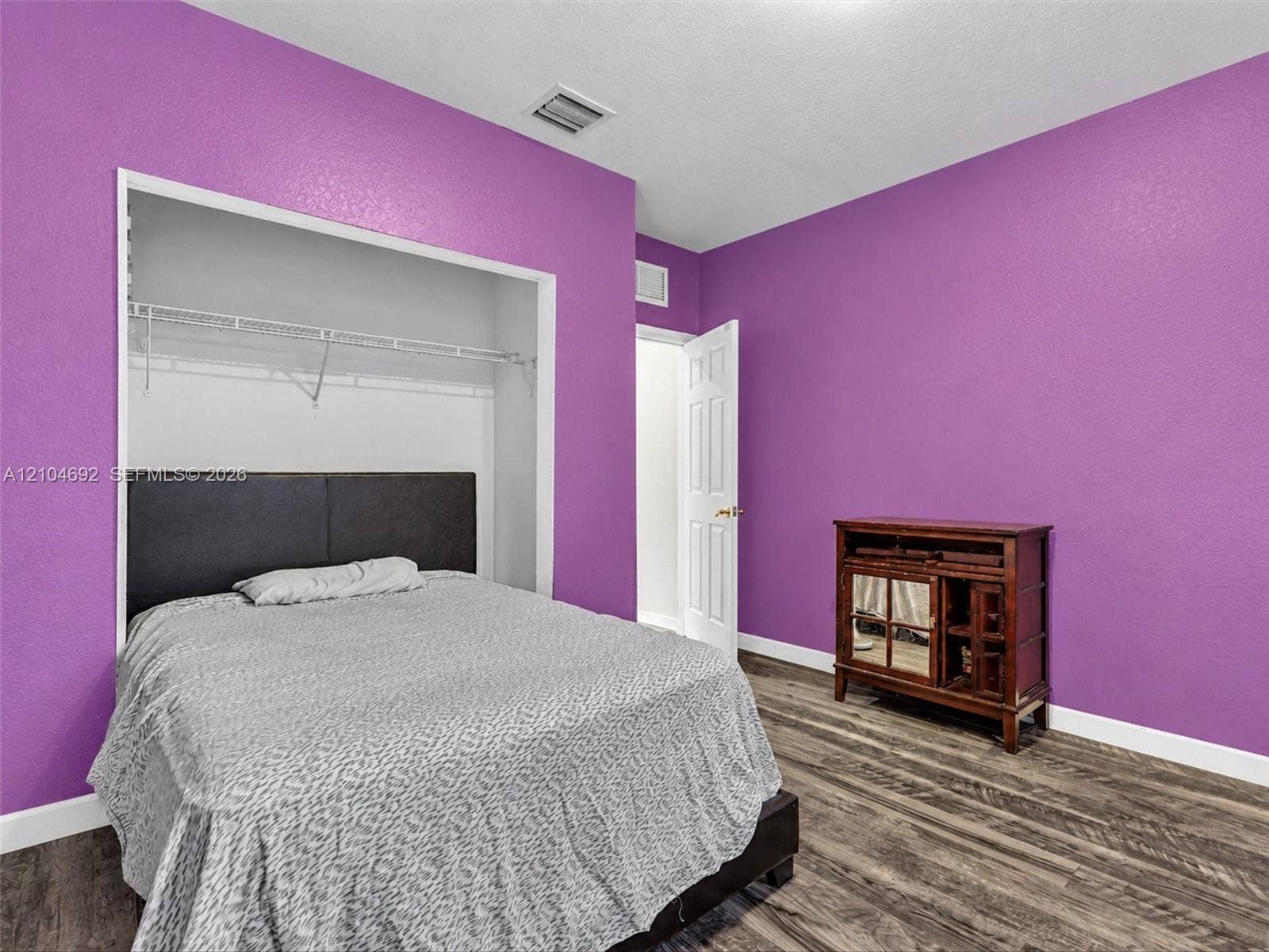 714 SE 37th Place, Homestead, FL 33033 Wood-finish flooring and a walk-in closet featuring wire shelving
