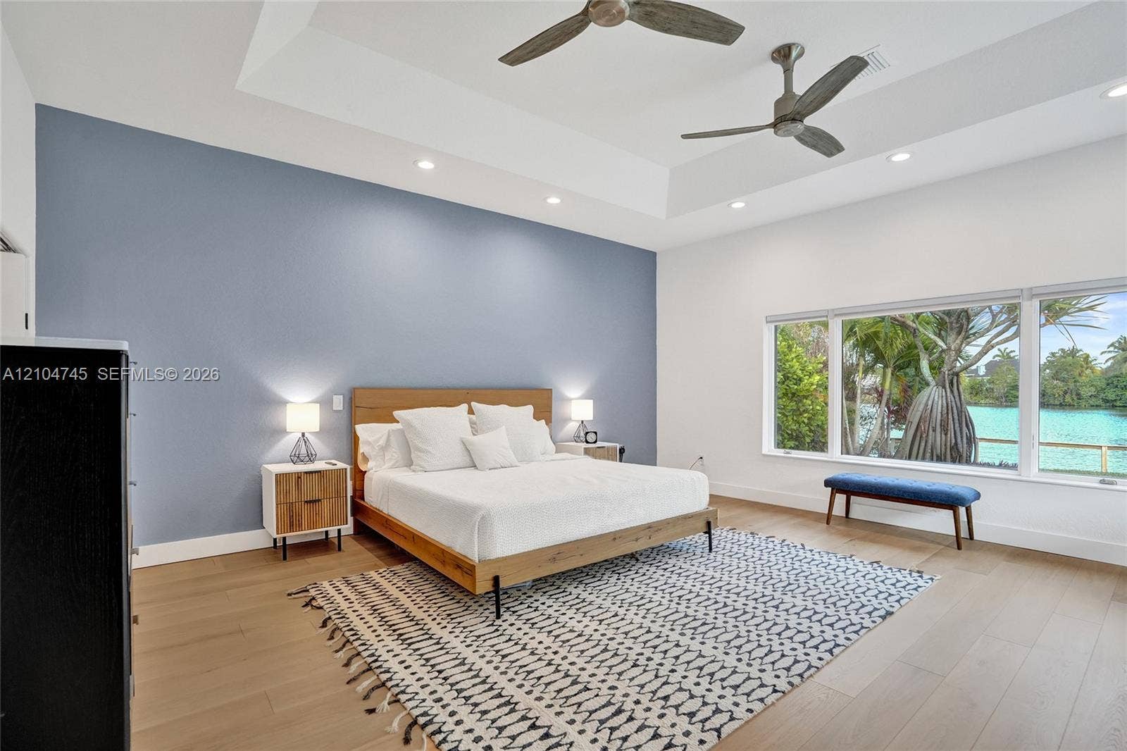 Tray ceiling with recessed lighting and two ceiling fans