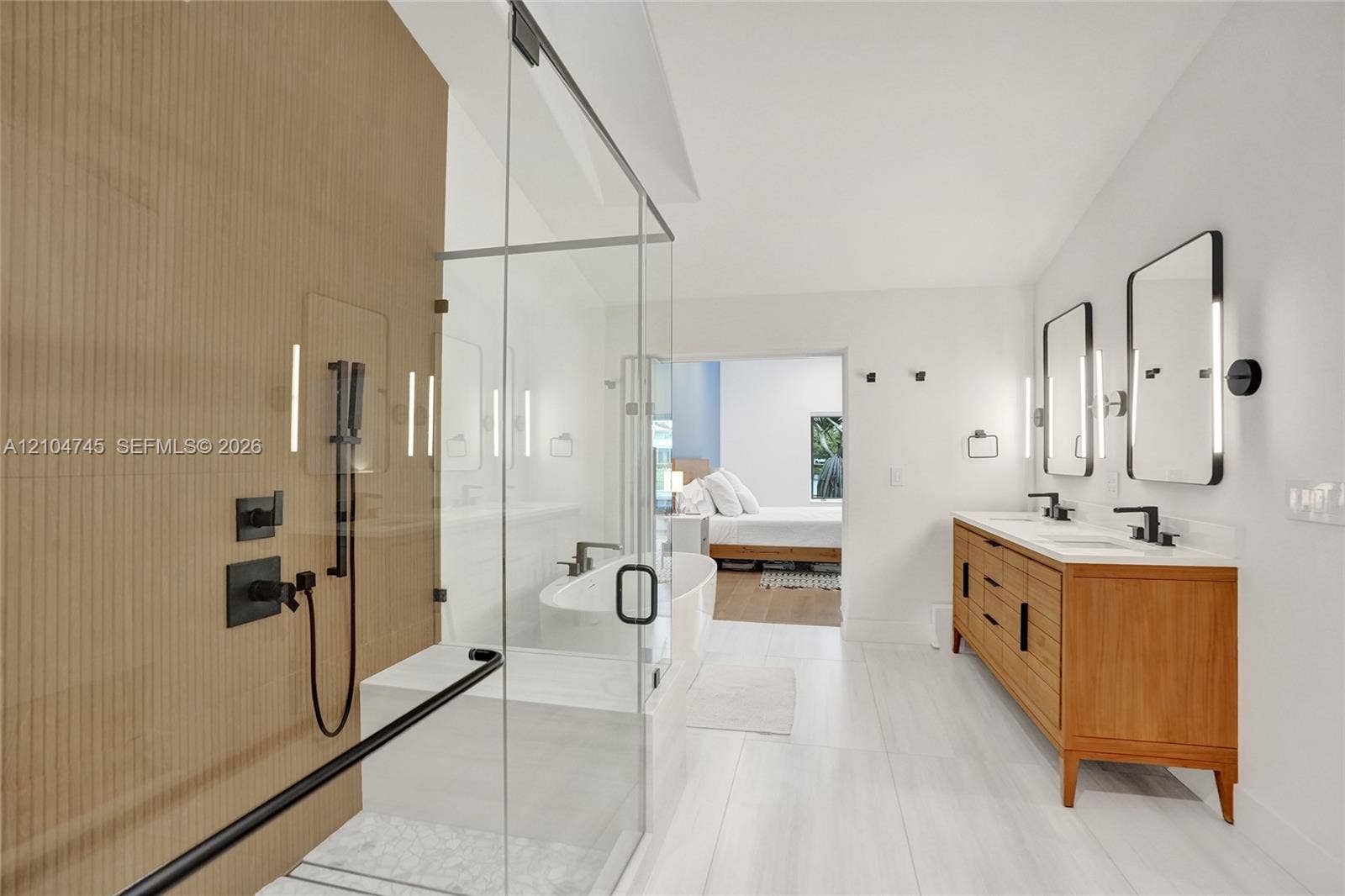 Dual vanity with rectangular sinks, wood-finish cabinetry, and matte black fixtures