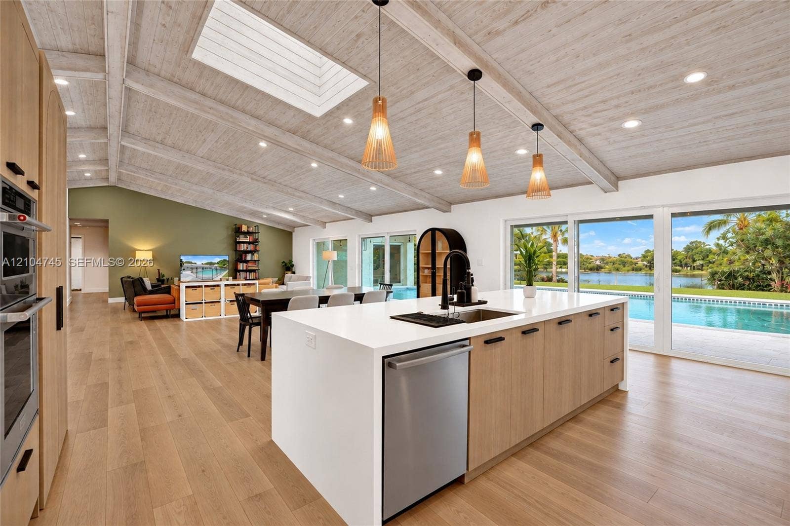Vaulted wood-finish ceiling with exposed beams and skylight