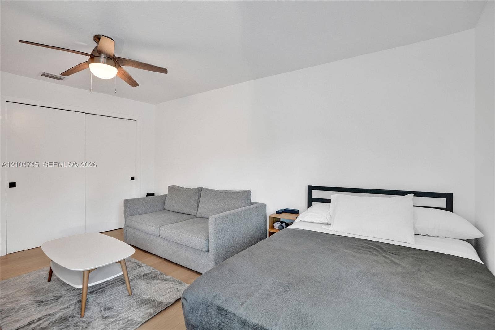 Wood-finish flooring with a ceiling fan light fixture