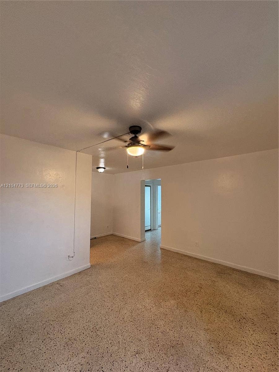 Terrazzo flooring with a matte finish, ceiling fan with integrated lighting, and recessed lighting