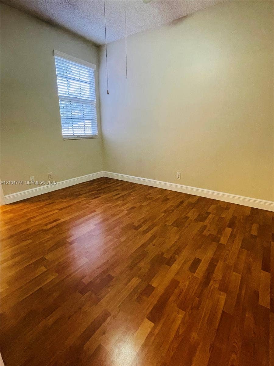 1503 Veracruz Lane, #5-14, Weston, Weston, FL 33327 Wood-finish flooring, neutral wall tones, and window featuring horizontal blinds