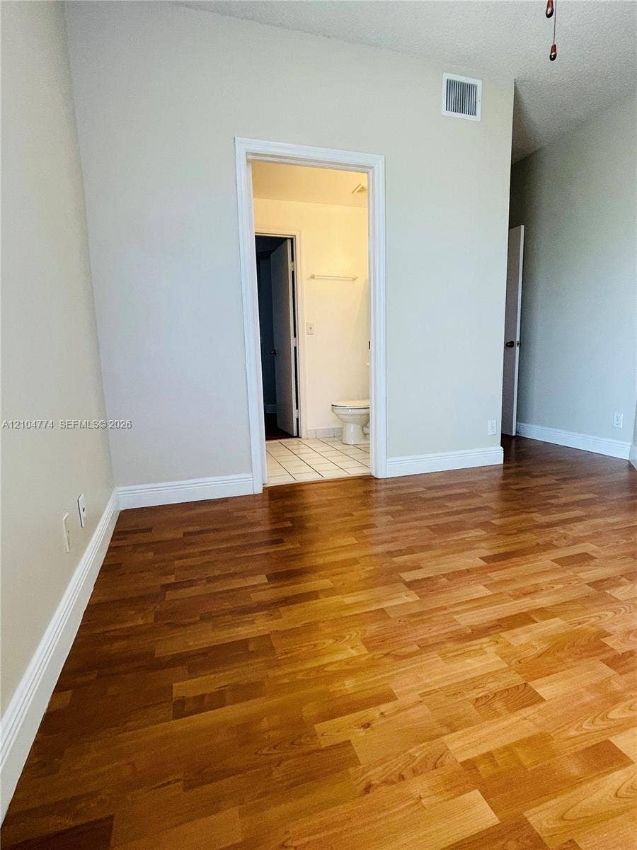 1503 Veracruz Lane, #5-14, Weston, Weston, FL 33327 Wood-finish flooring throughout, neutral wall tones, and tiled bathroom flooring