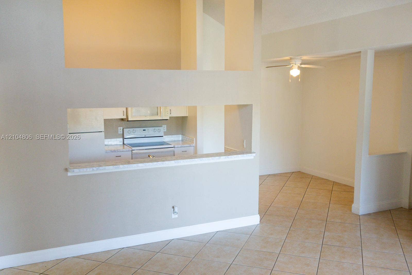 10451 SW 157th Place, #303, Miami, FL 33196 Kitchen pass-through with a breakfast bar, stainless steel range, and ceiling fan