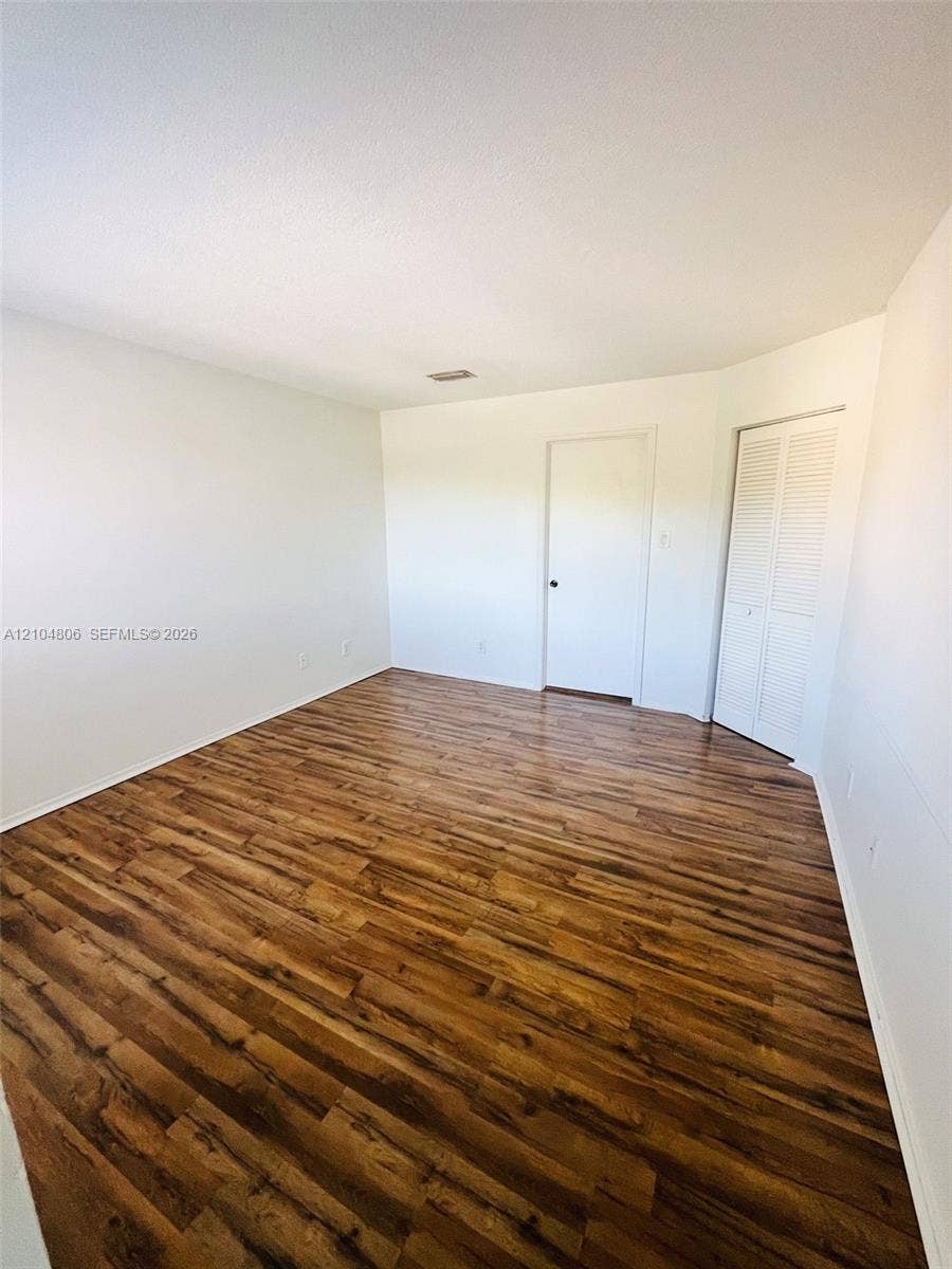 10451 SW 157th Place, #303, Miami, FL 33196 Wood-finish flooring with white walls