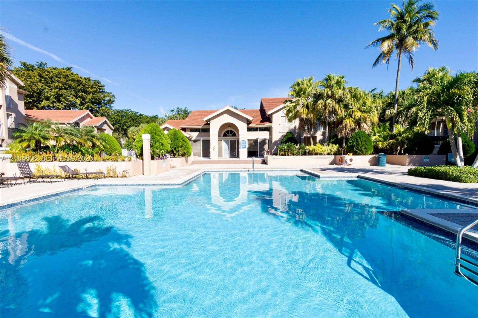 10451 SW 157th Place, #303, Miami, FL 33196 Expansive outdoor swimming pool with surrounding deck