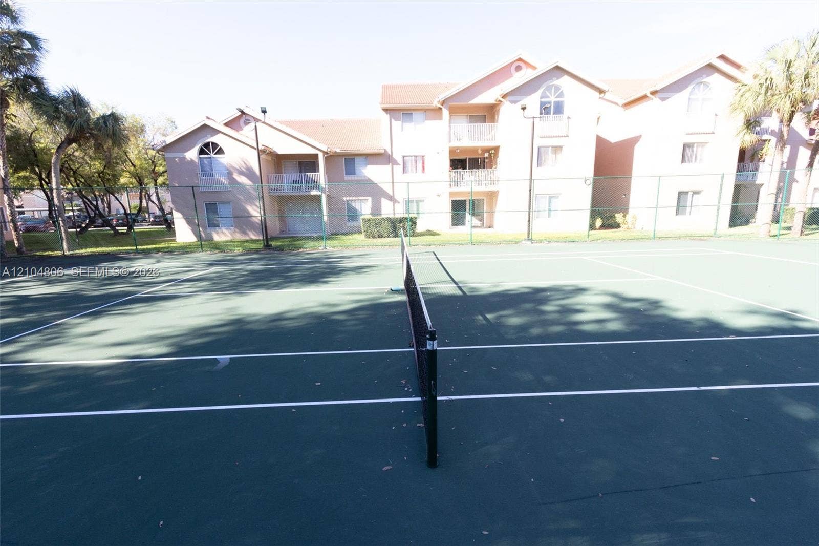 10451 SW 157th Place, #303, Miami, FL 33196 Tennis court featuring a green playing surface and white court lines