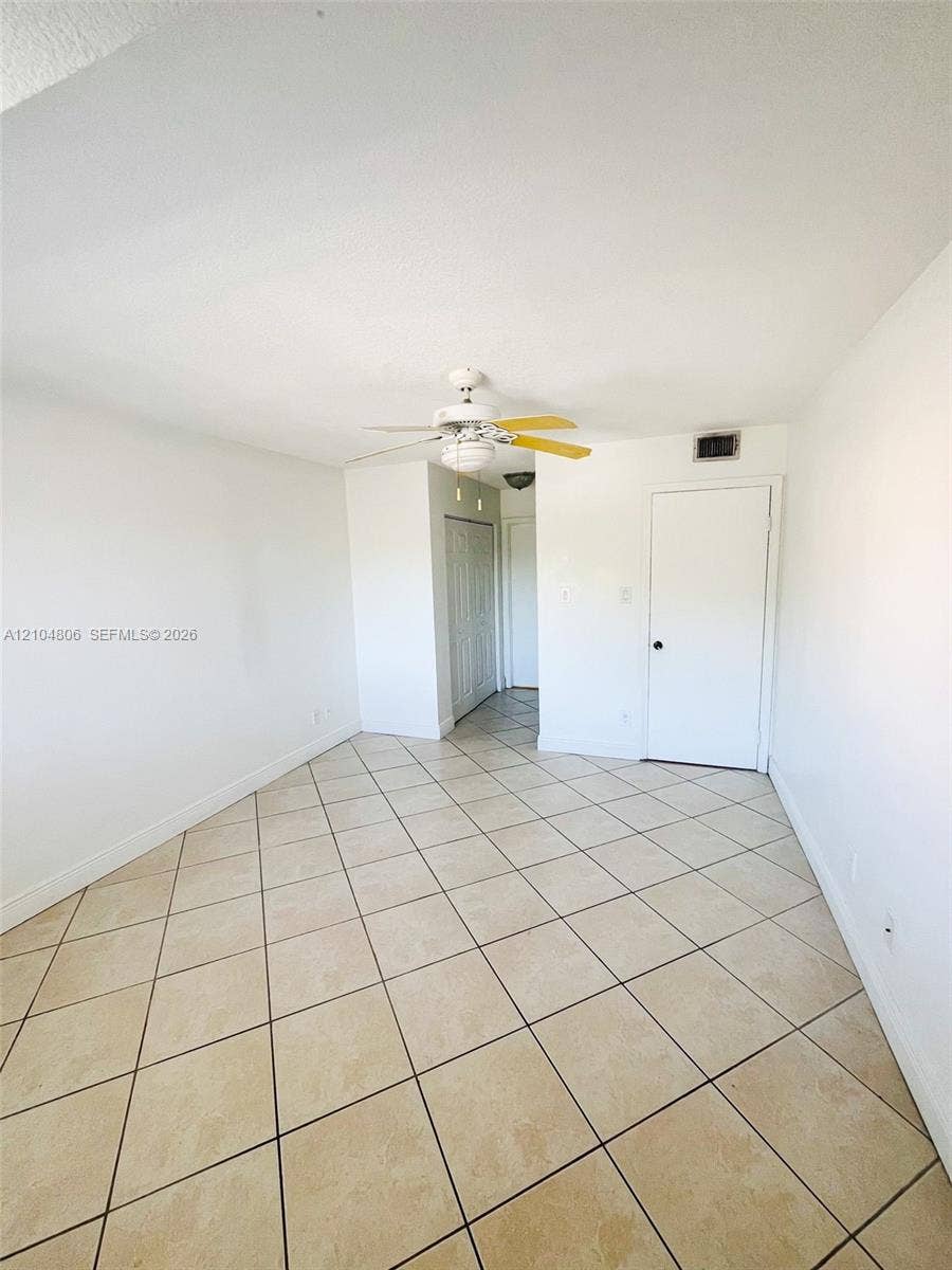10451 SW 157th Place, #303, Miami, FL 33196 Tile flooring with a neutral finish, white walls, and a ceiling fan