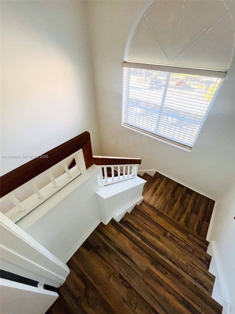 10451 SW 157th Place, #303, Miami, FL 33196 Wood-finish flooring on staircase with white risers
