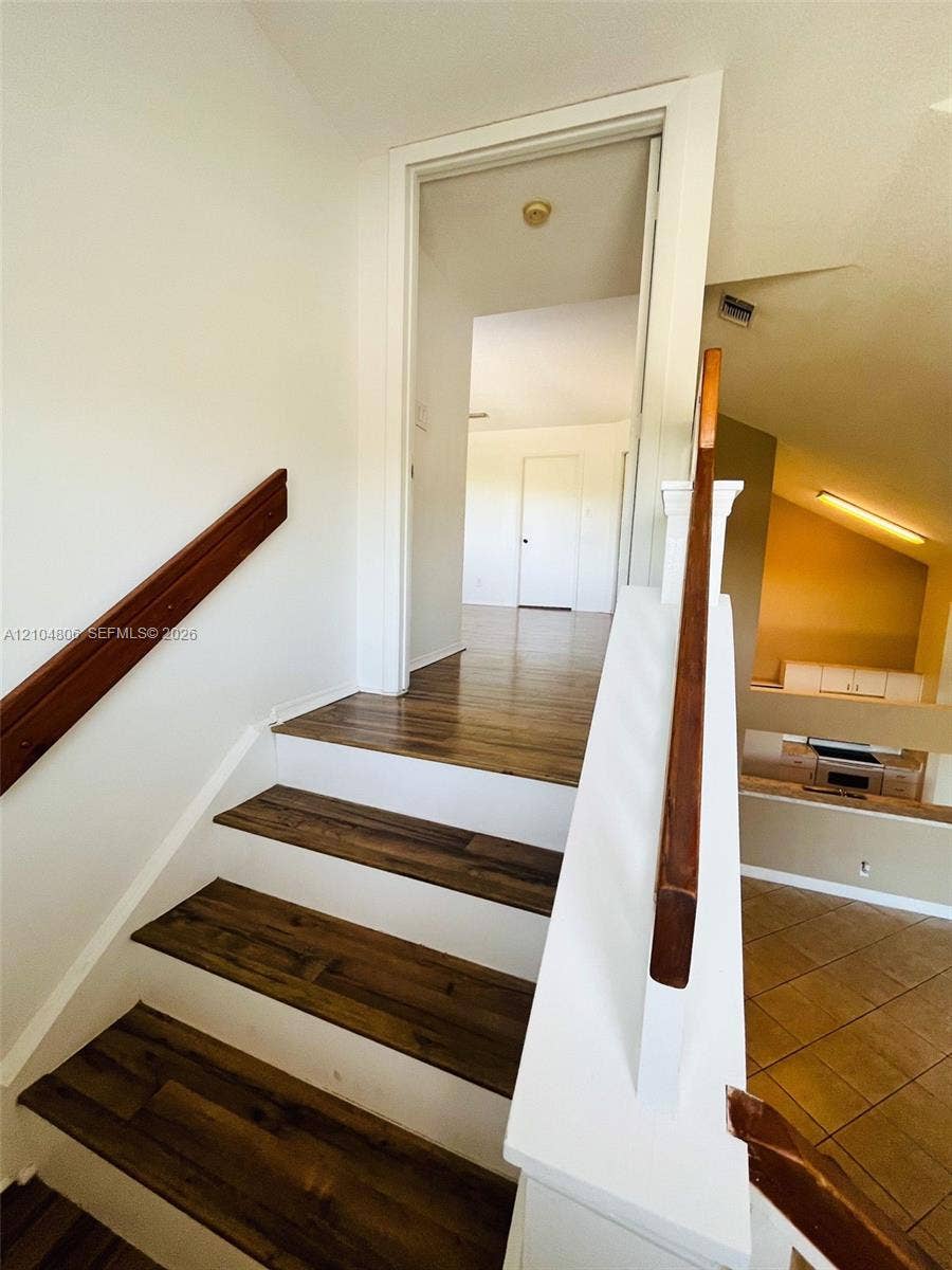 10451 SW 157th Place, #303, Miami, FL 33196 Staircase featuring wood-finish treads and white risers