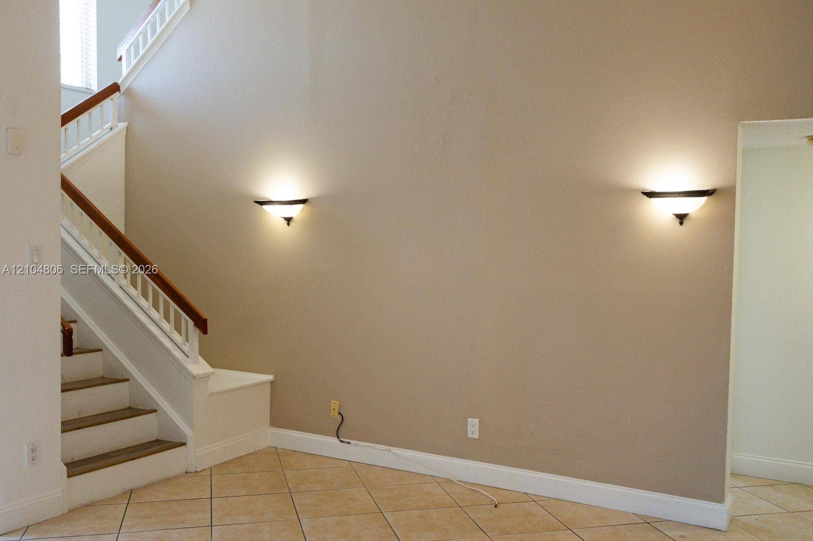 10451 SW 157th Place, #303, Miami, FL 33196 Staircase with wood handrail, white balusters, and painted risers
