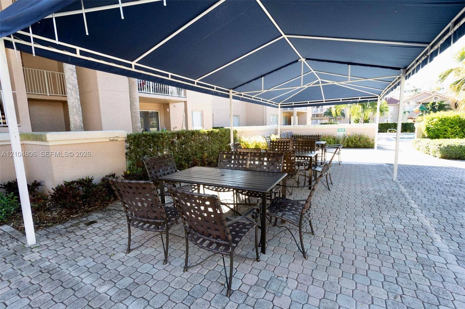 10451 SW 157th Place, #303, Miami, FL 33196 Paved patio area featuring a fixed overhead canopy
