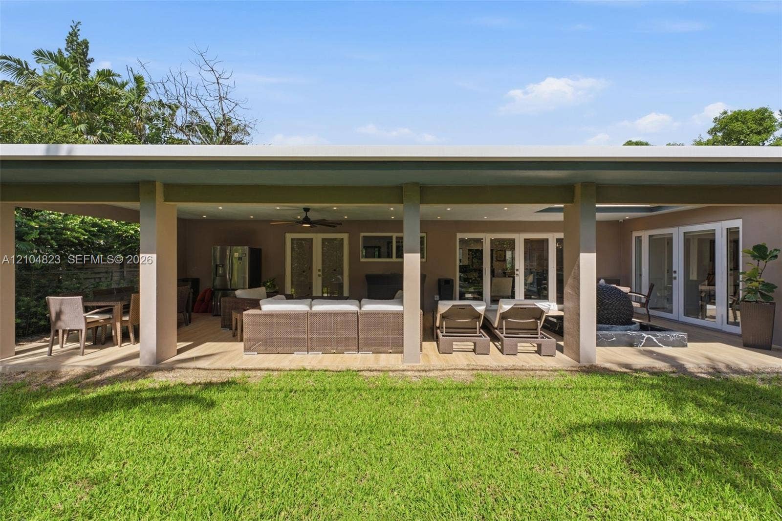 291 E Shore Drive E, Miami, FL 33133 Expansive covered patio featuring a wood-finish deck, recessed lighting, and multiple sets of French doors