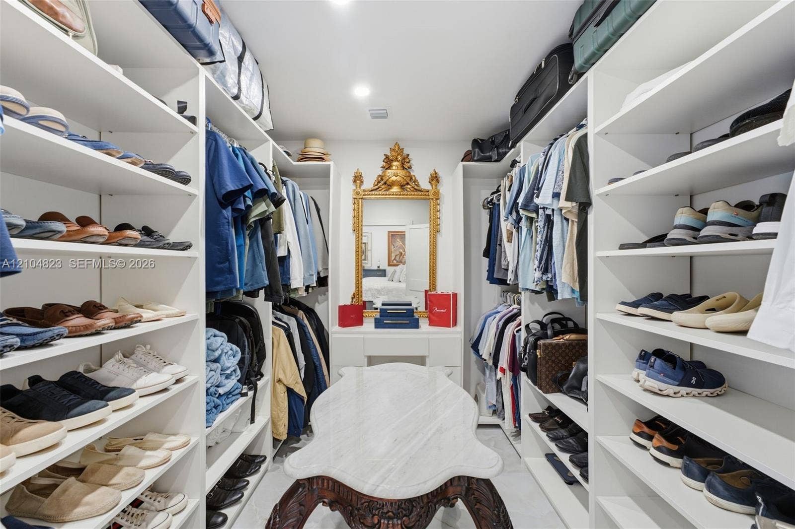291 E Shore Drive E, Miami, FL 33133 Custom closet system with extensive shelving, integrated hanging rods, and recessed lighting
